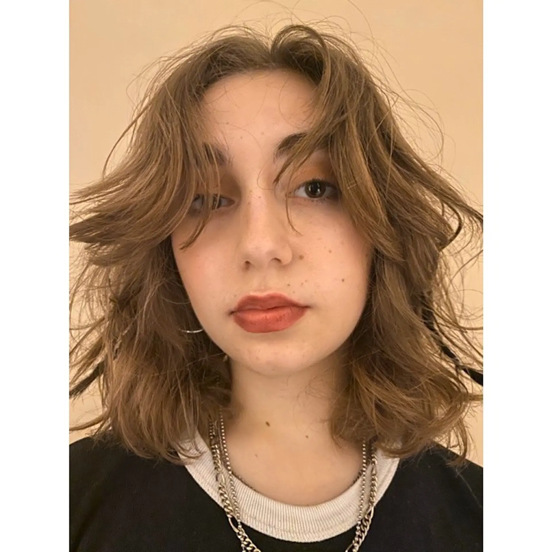 A medium-length shaggy hairstyle with lots of layers and face-framing bangs for a modern twist on a classic look. 1