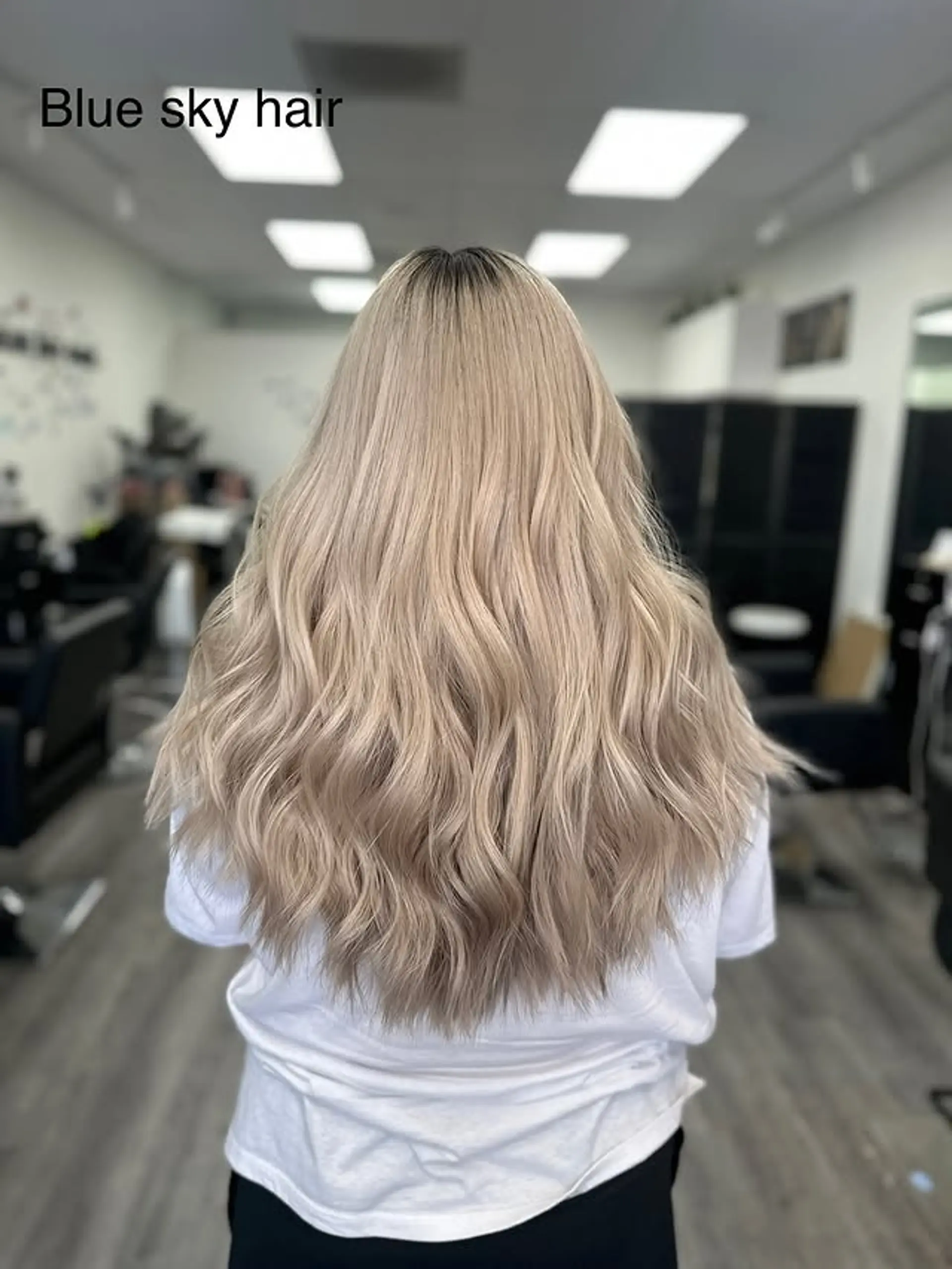 Long, flowing wavy hair with a blend of blonde and ash blonde tones. 1
