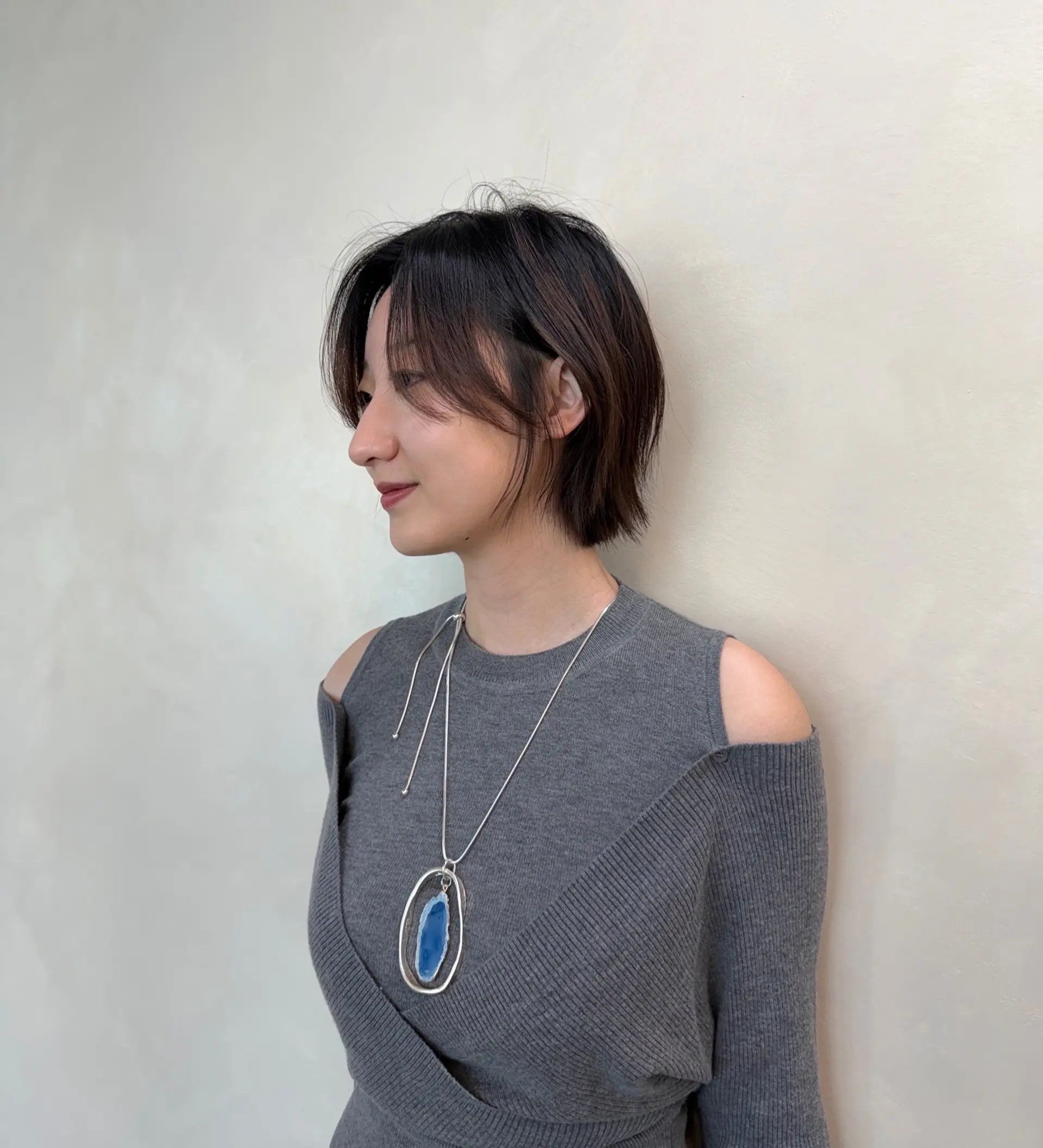A sleek, chin-length layered bob with soft, wispy bangs and subtle face-framing pieces. 1