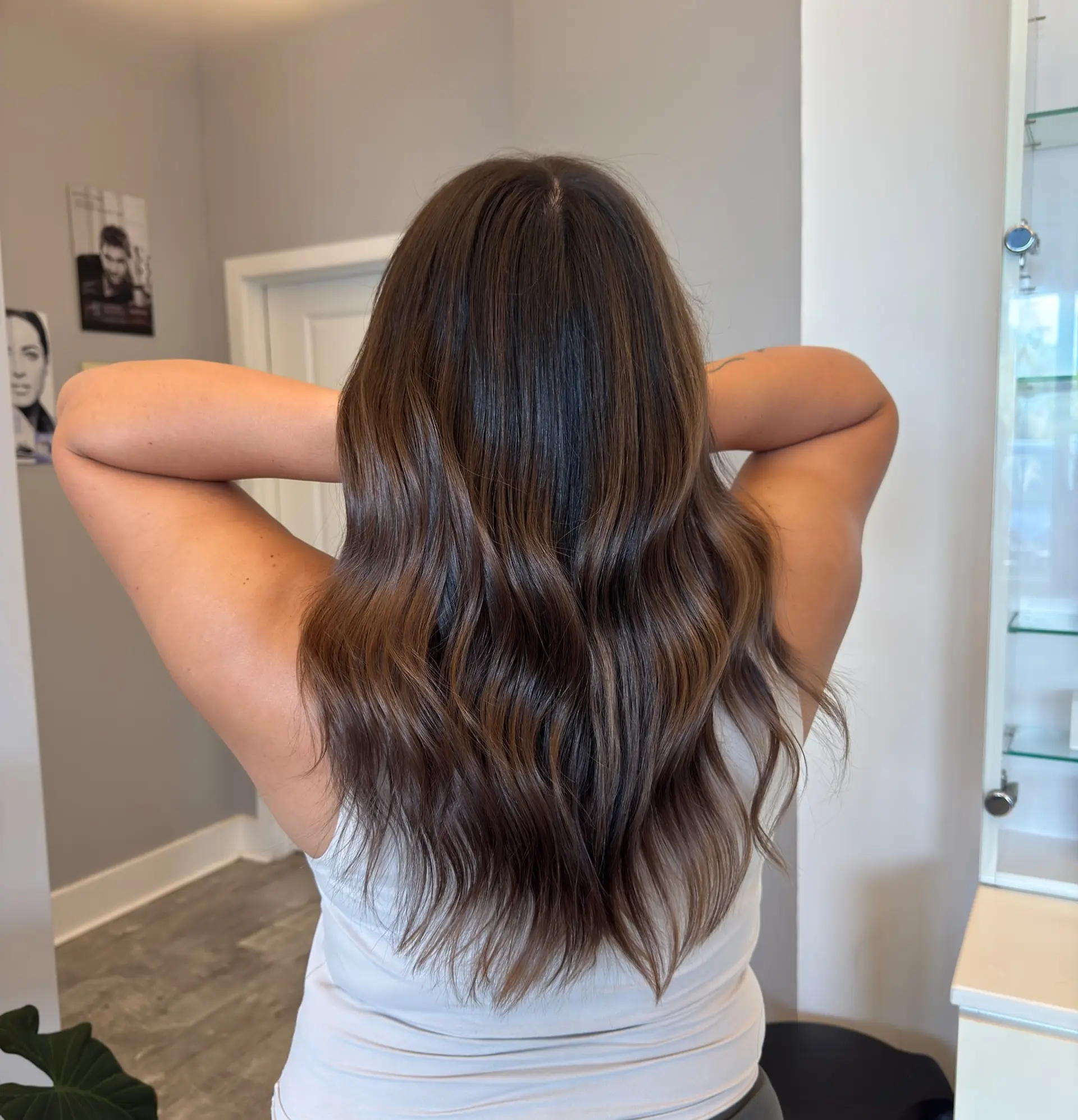 Long layered hair with subtle waves and a balayage bronde color melt. 1