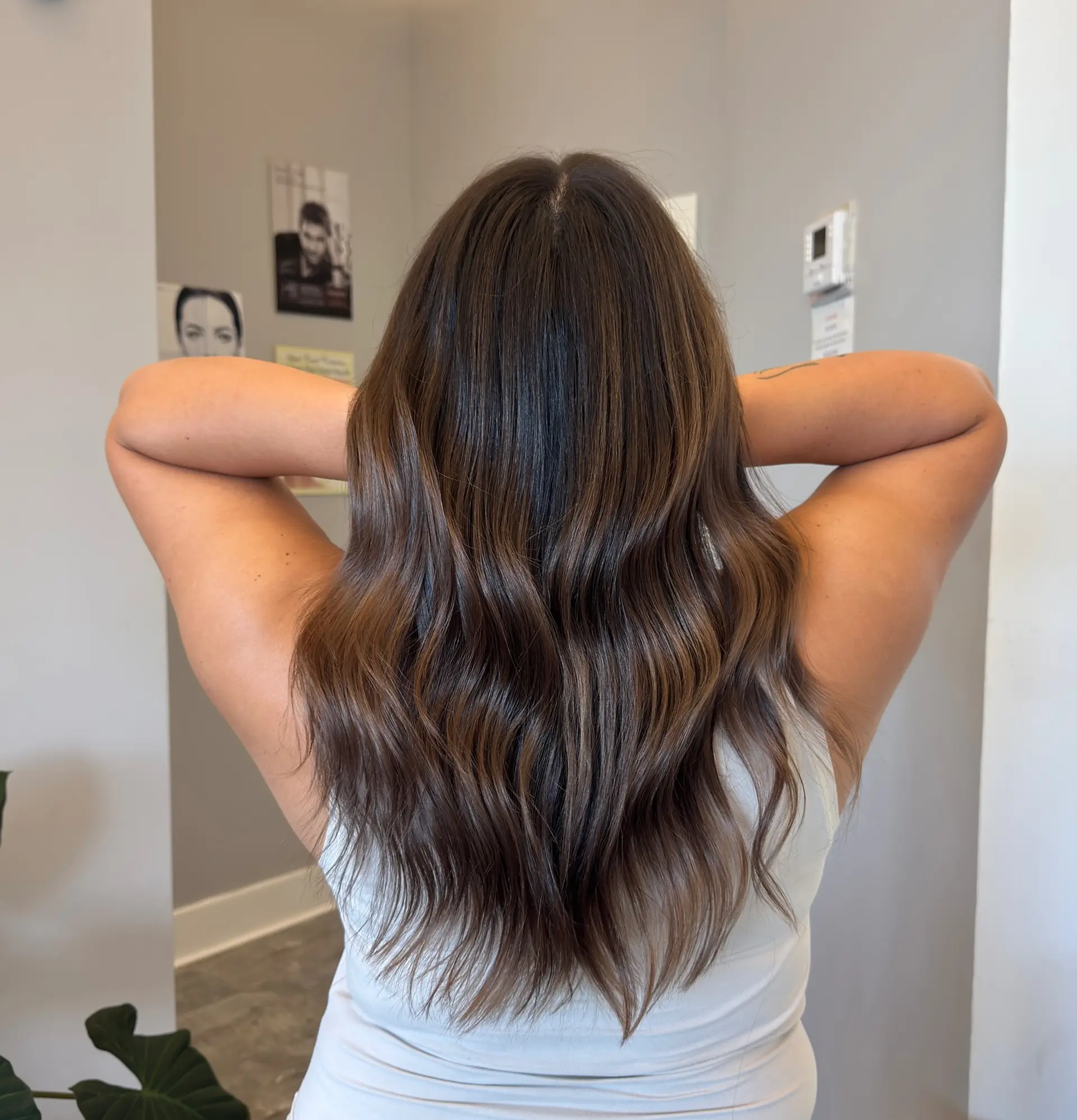 Long layered hair with subtle waves and a balayage bronde color melt. 2