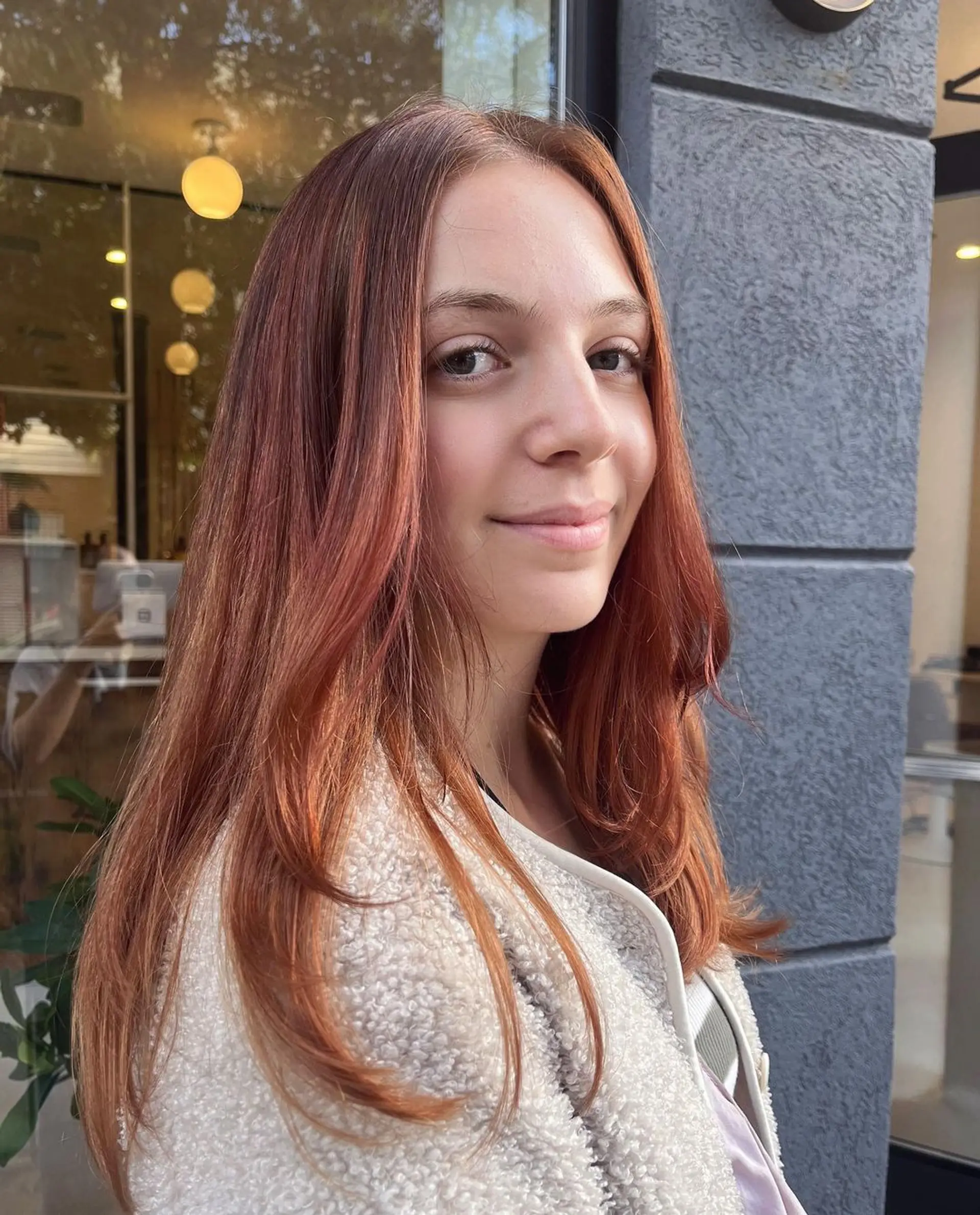 A long, straight hairstyle with a mix of red, copper, and auburn colors. Features soft layers, natural shine, and a middle part with face-framing strands. 1