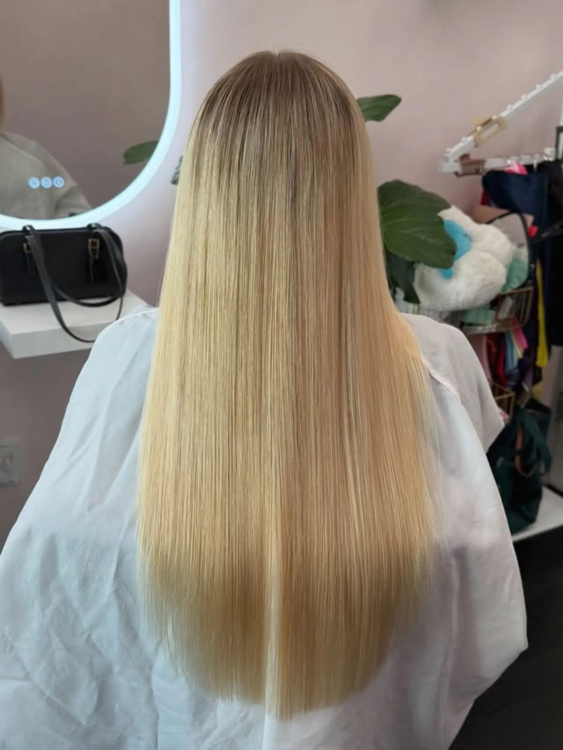 This style features very long, straight hair with a seamless transition from natural light brown roots to a vibrant blonde. The ends are cut blunt, giving it a sleek and polished finish. 1