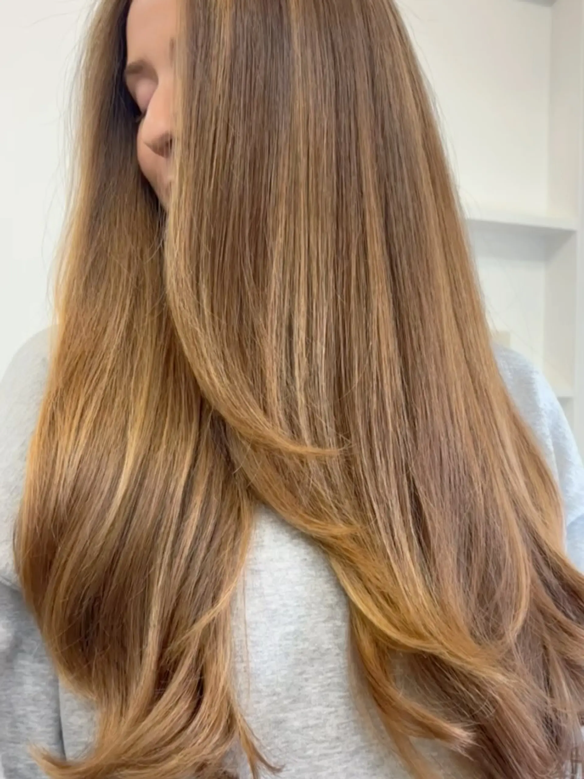 Long, flowing honey blonde hair styled smooth with soft face-framing layers and curved ends. 1