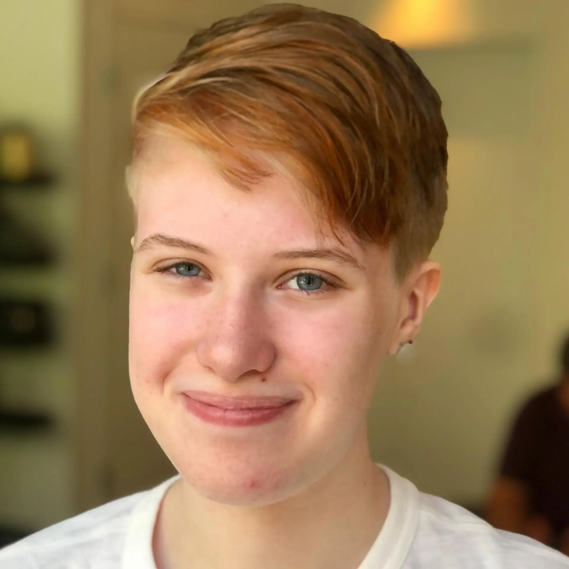 A textured short pixie cut with closely tapered sides and longer, side-swept copper fringe. 1