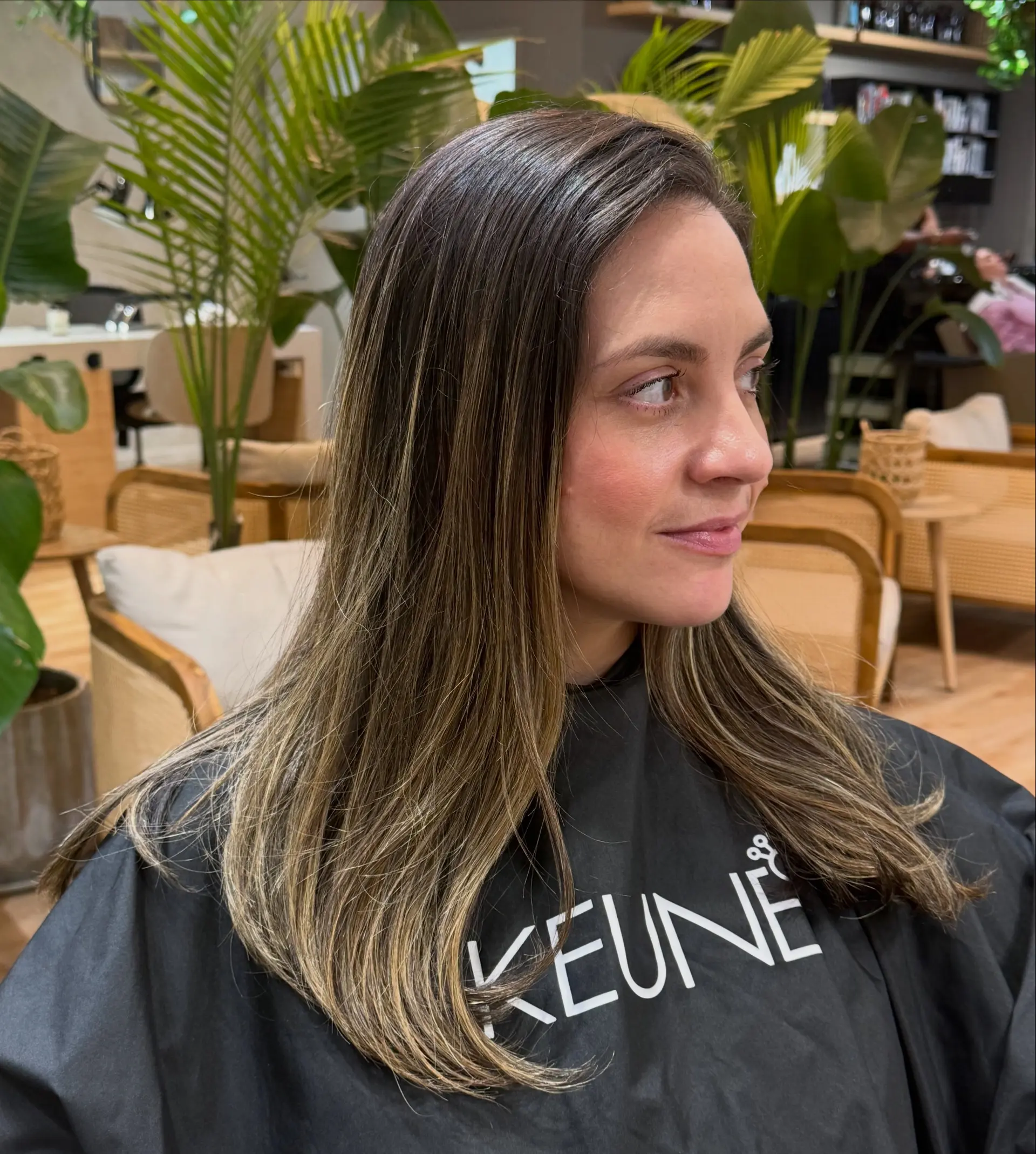 Long dark brown hair detailed with blended blonde highlights and a smooth, softly curved blowout finish. 1