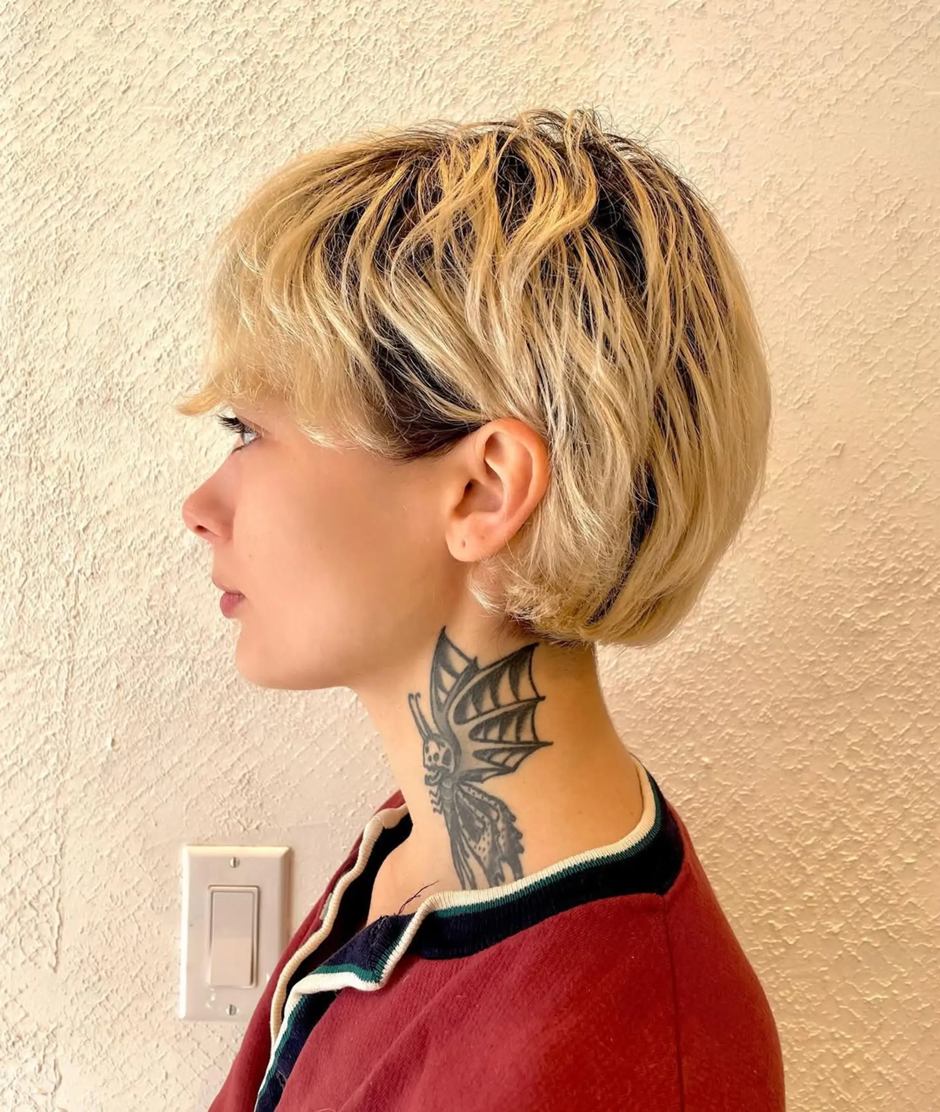 A short, wavy hairstyle with soft, tousled layers. Blonde in color, it has face-framing strands and a natural, casual finish. 2