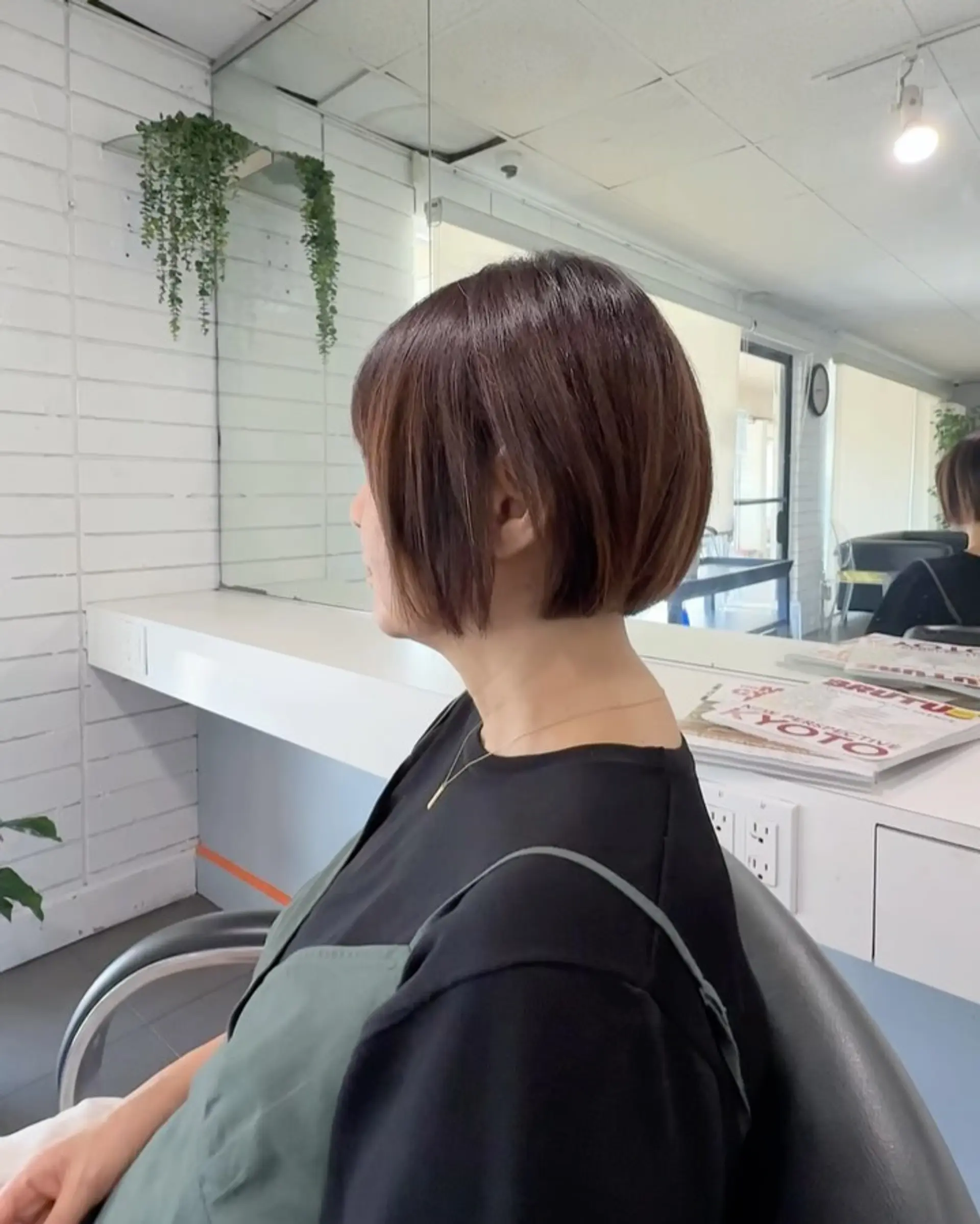 A rounded short bob haircut with soft volume through the back and slightly longer front pieces around the face. 1