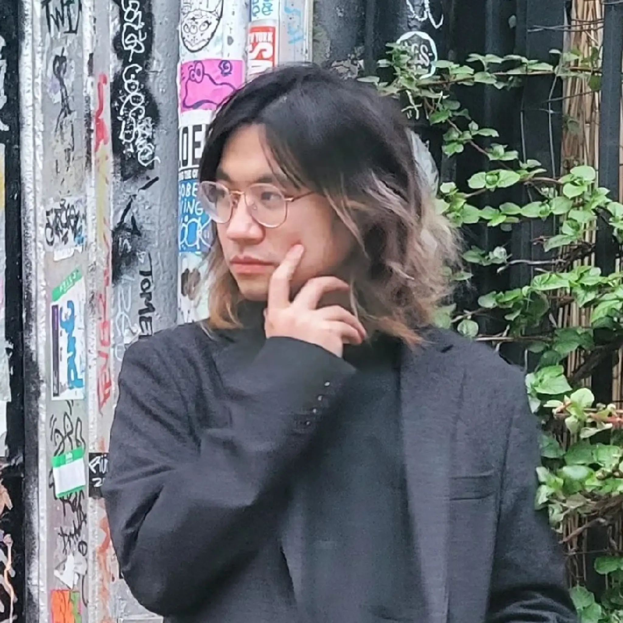 Medium-length, wavy hair with a two-tone black and ash brown color, featuring loose waves and a textured, casual chic style.