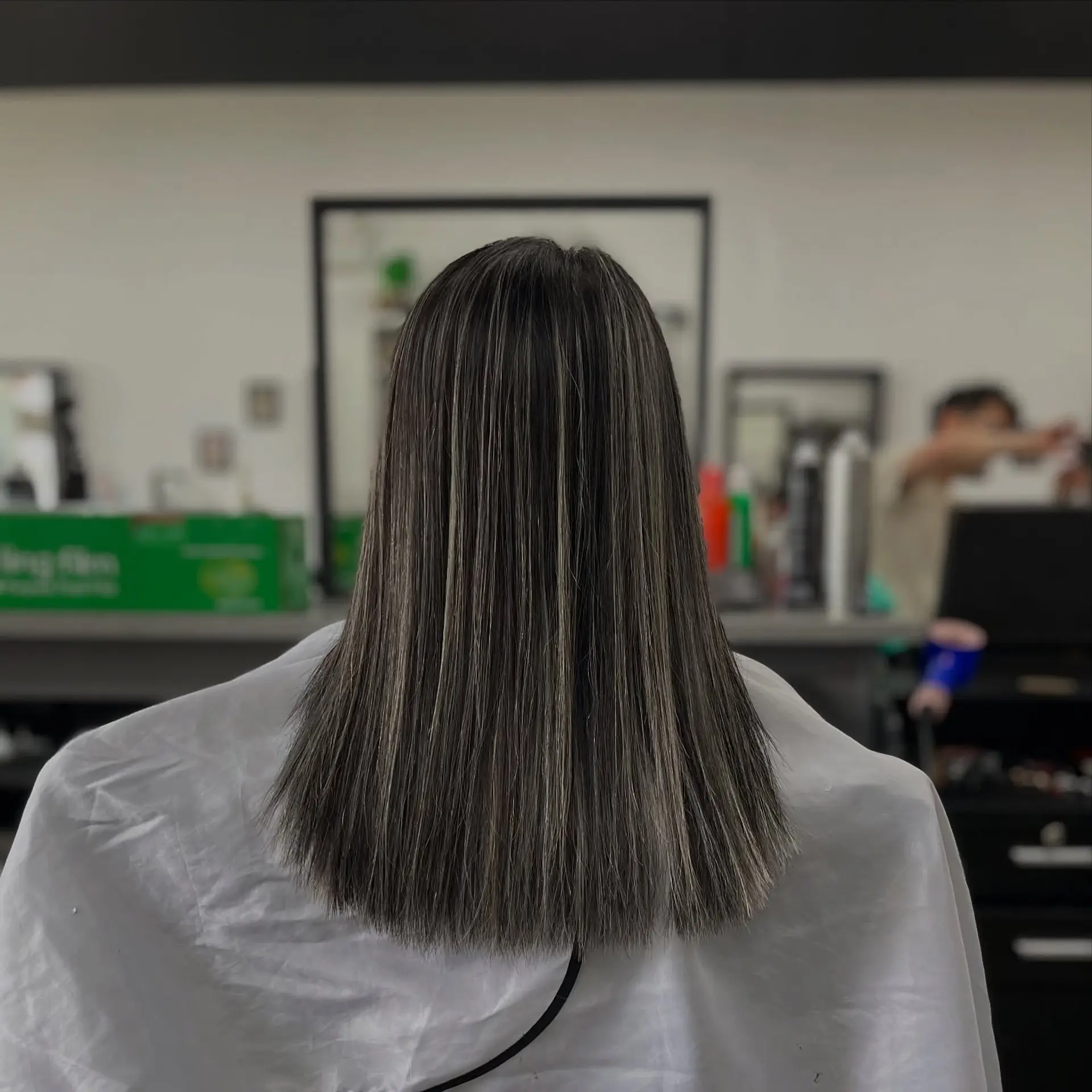 A sleek and modern medium-length lob with ash blonde highlights. 1