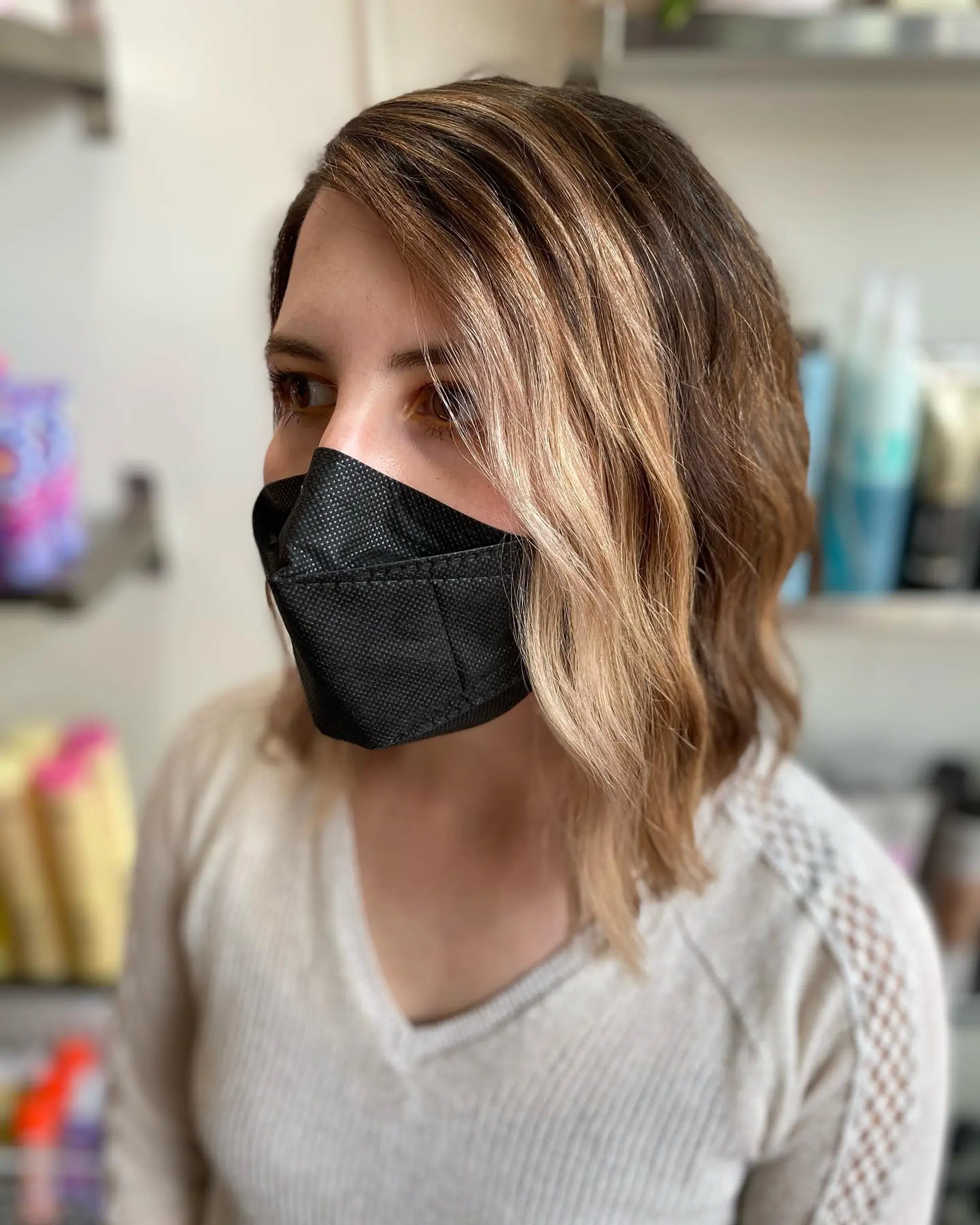 A textured shoulder-length bob styled with soft, undone waves and a side part. 1