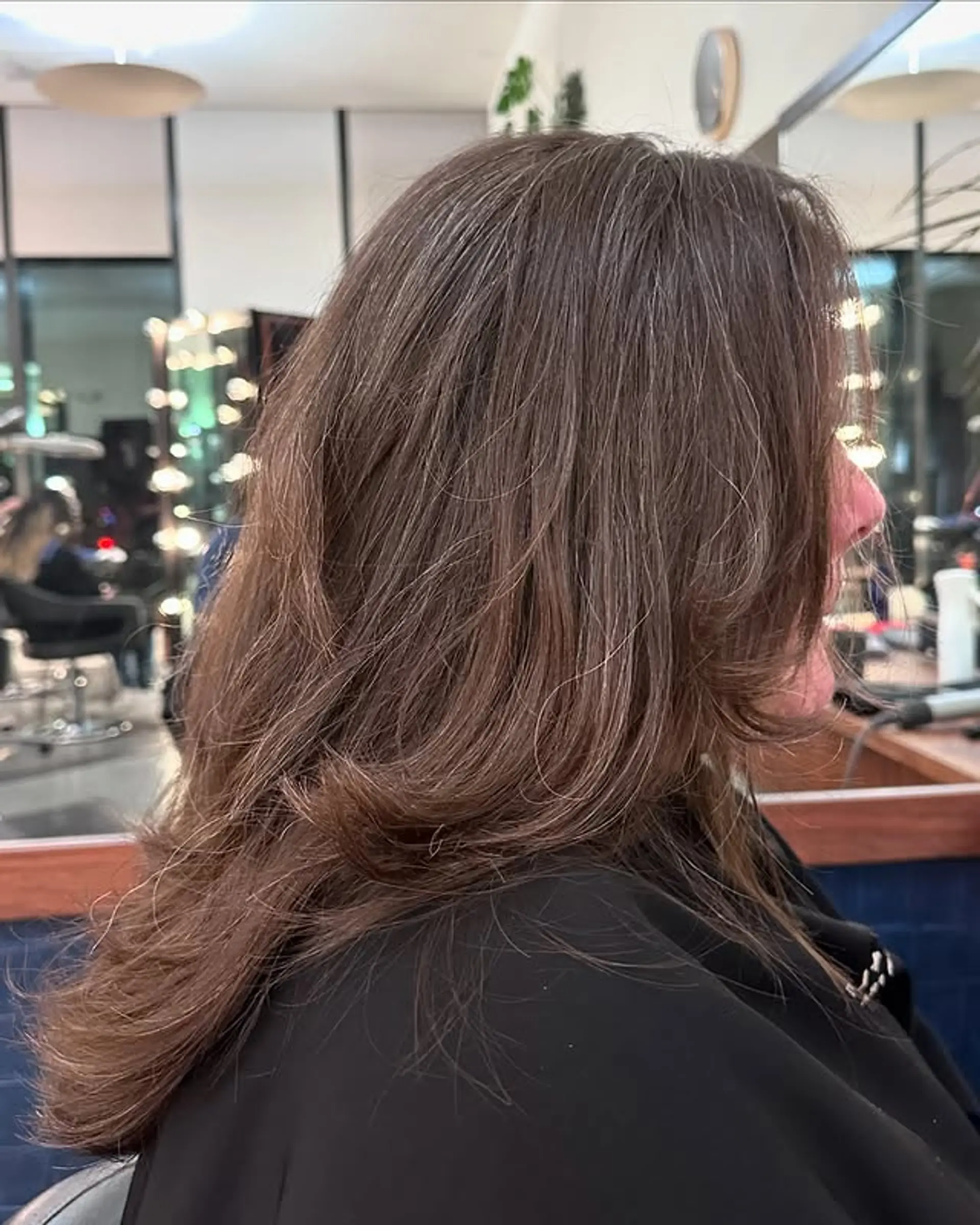 A layered medium-length cut with bronde balayage and face-framing. 1