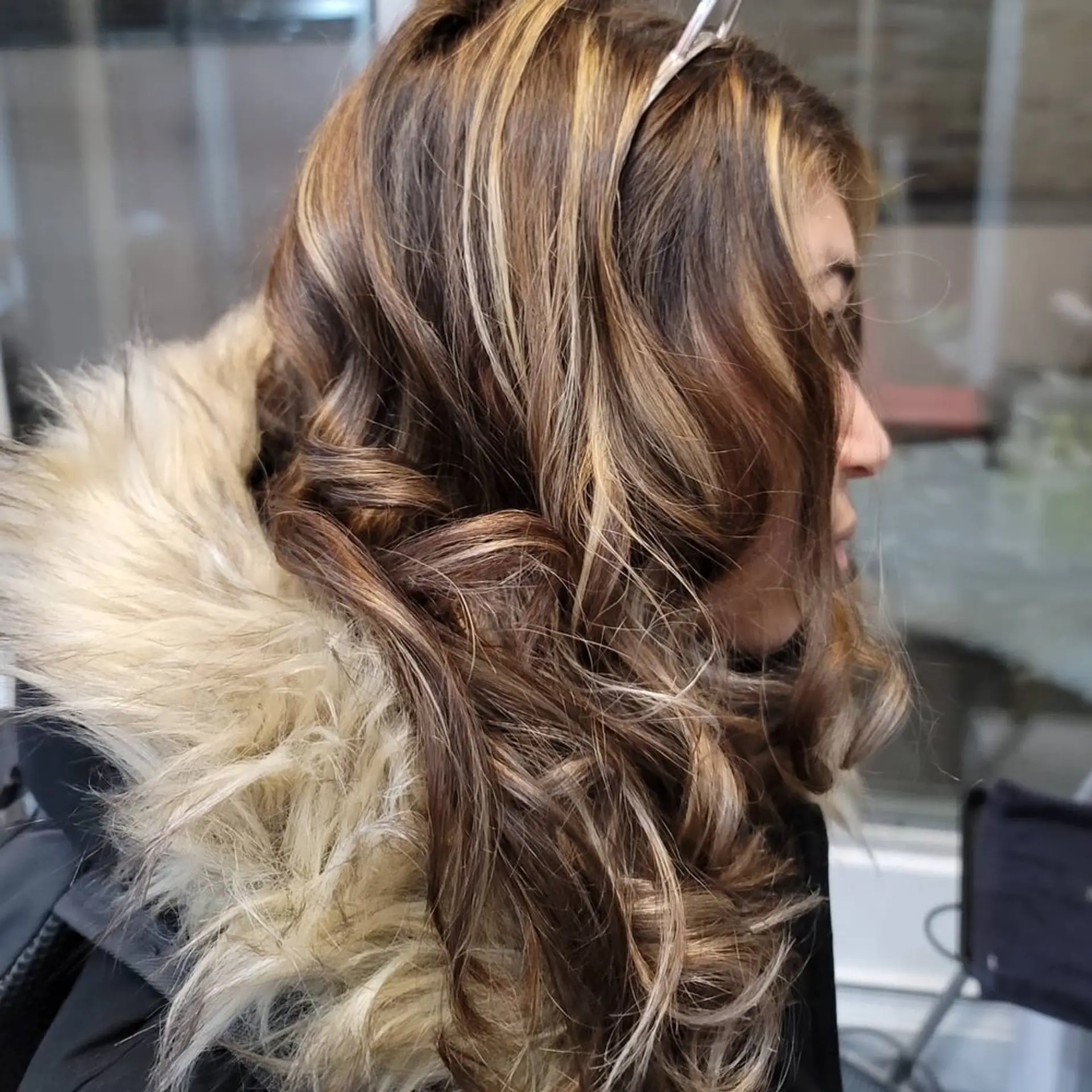 Long, voluminous curly hair with striking golden highlights and layers for added depth and movement. 1