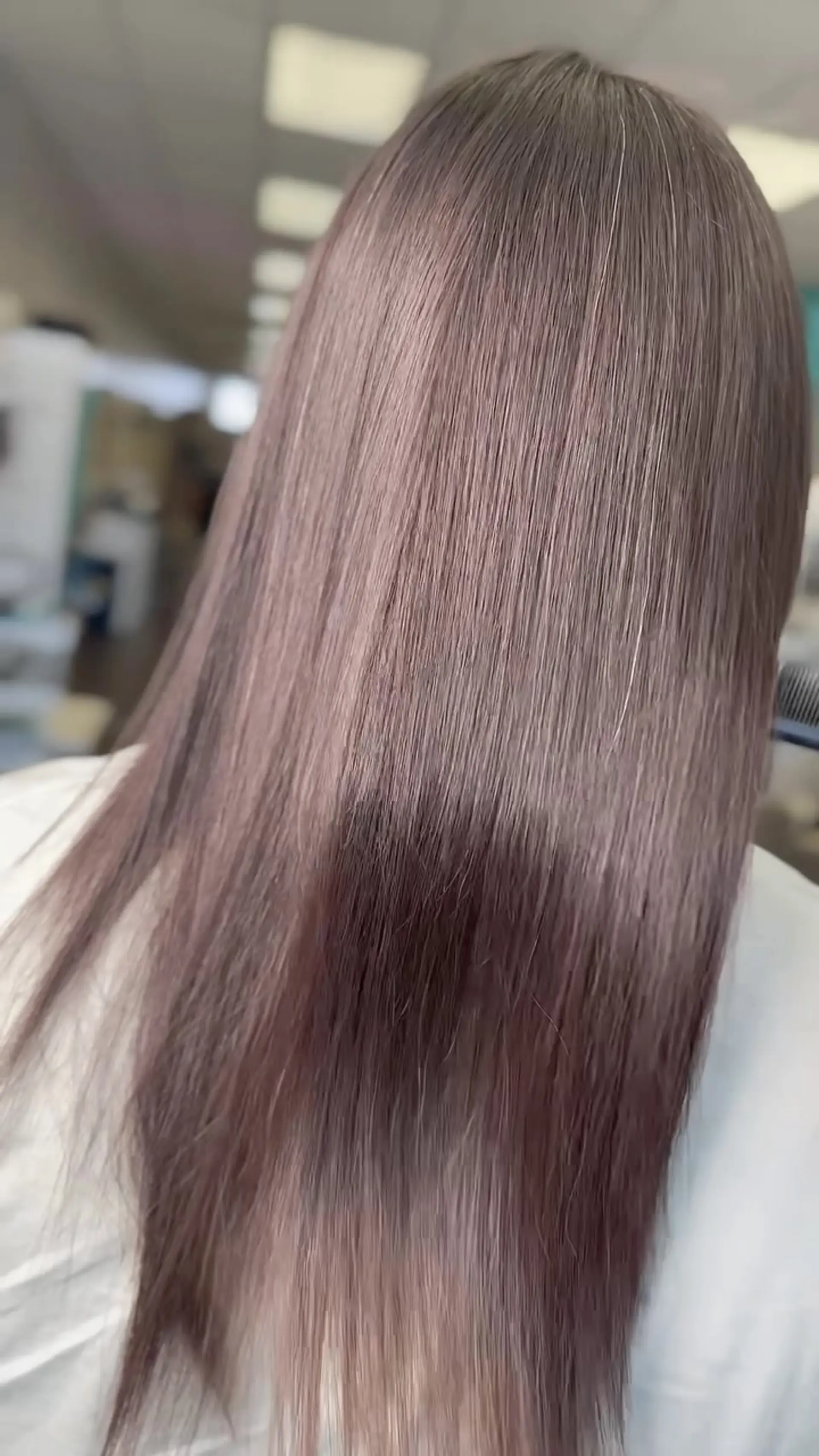 Ultra-smooth, glossy long hair styled pin-straight with a high-shine finish. 1