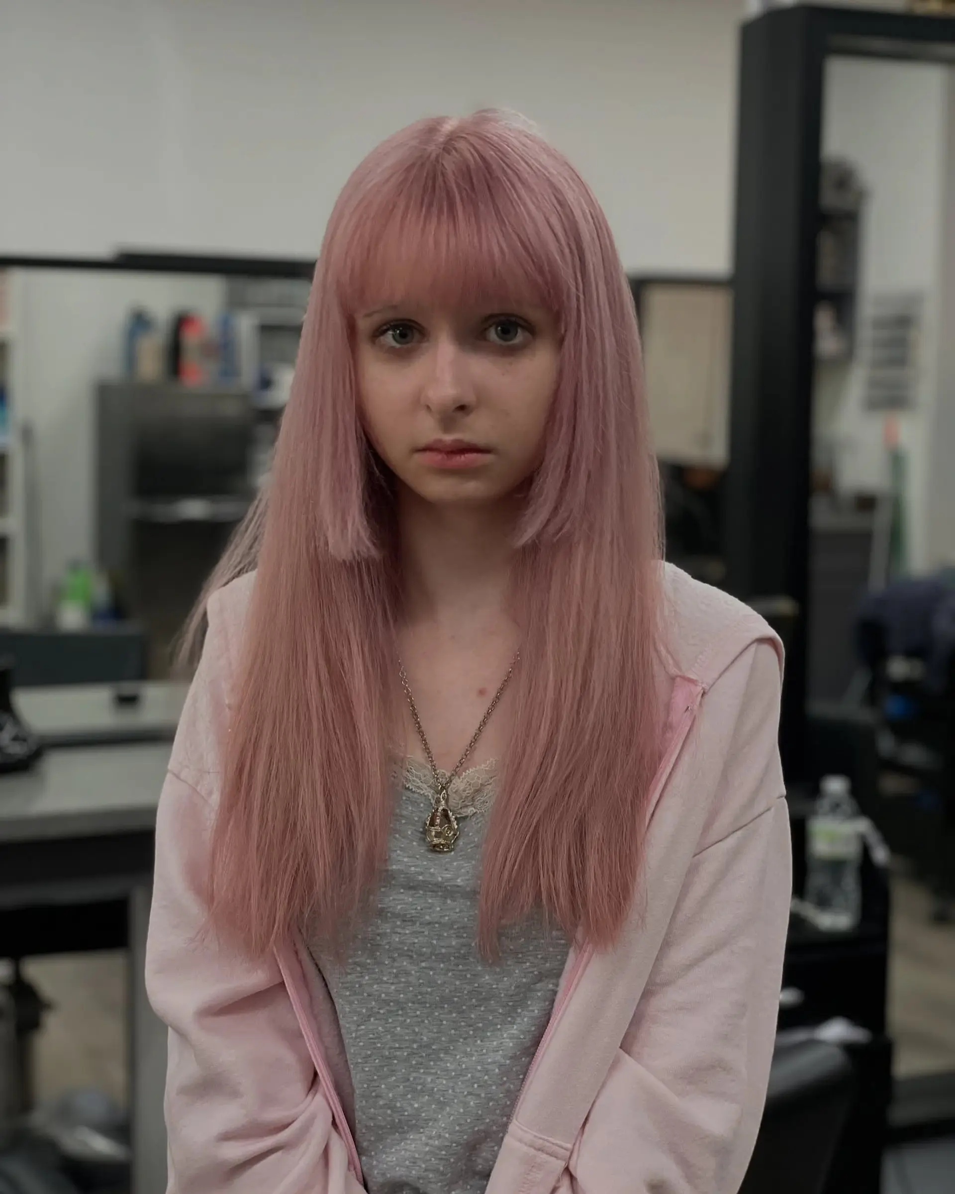 This style features long, straight hair with face-framing layers, full bangs, and a shaggy texture. 1