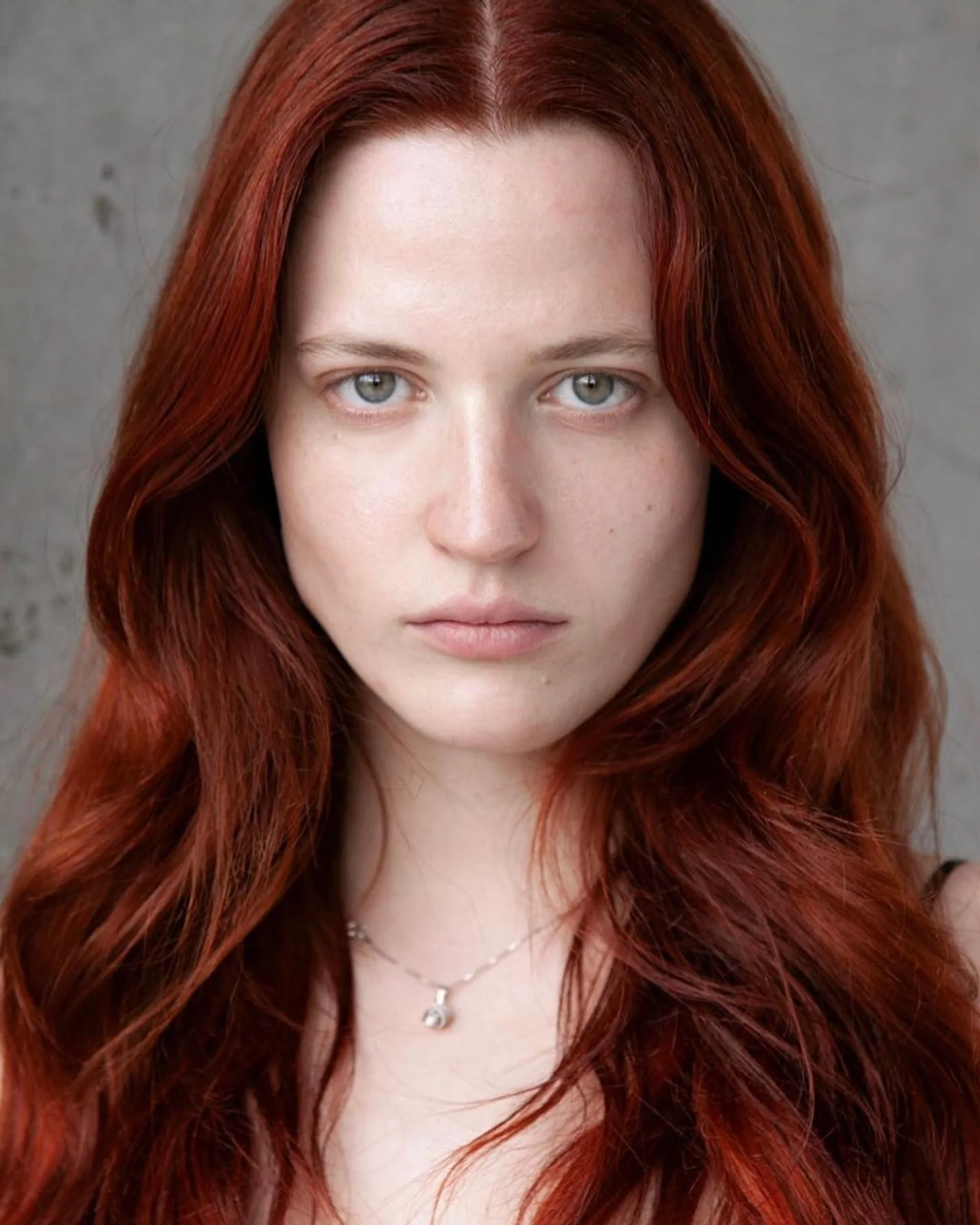 A model with ultra-sleek, long, dark hair exemplifying the 2025 Glass Hair Perfection trend. - Preview 3