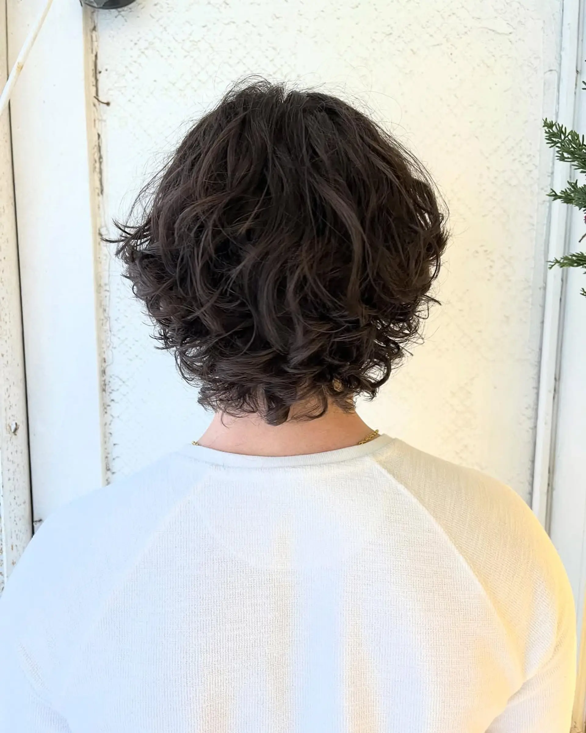 Medium-length wavy hair with a middle part, natural waves, and textured layers for a relaxed look. 2