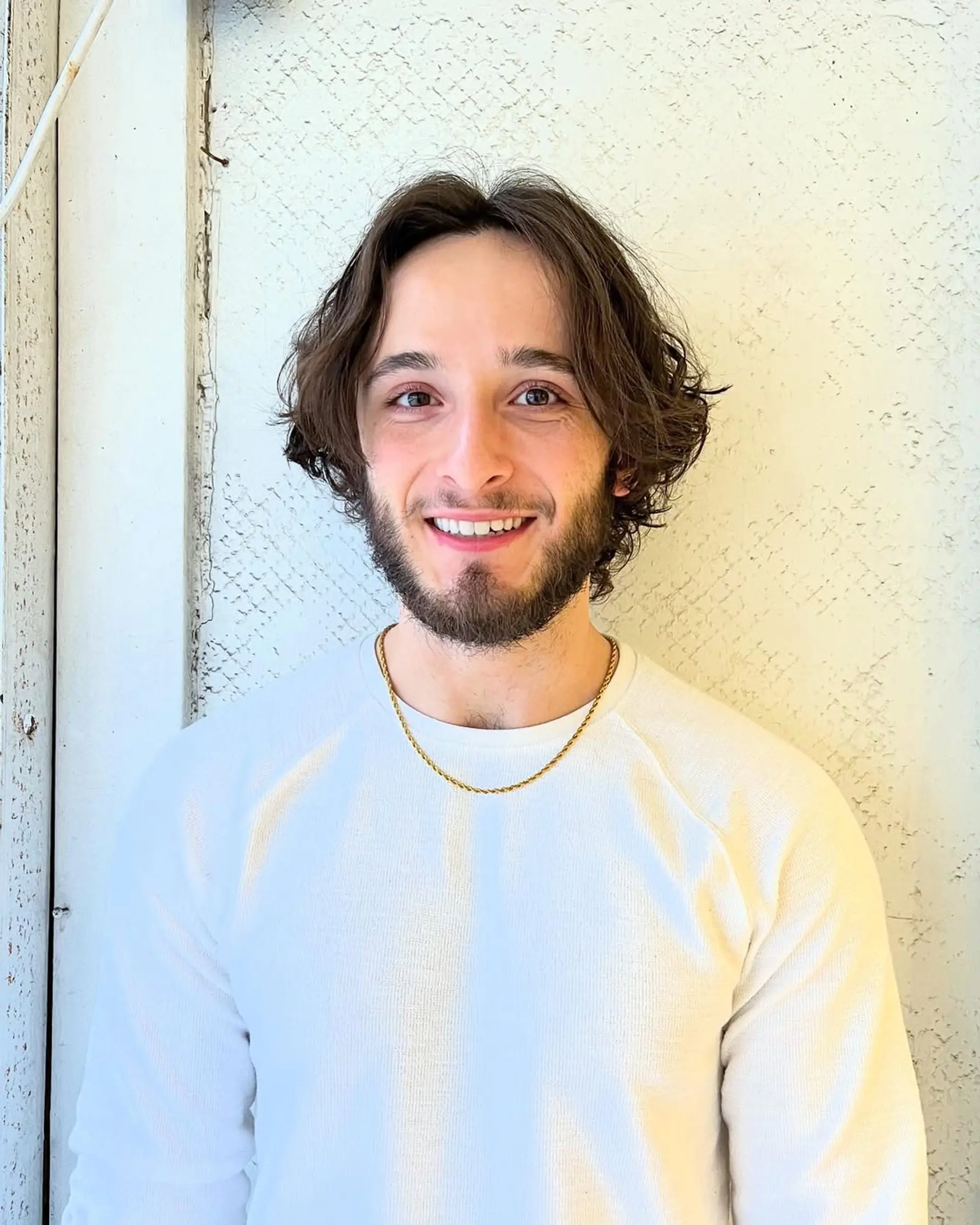 Medium-length wavy hair with a middle part, natural waves, and textured layers for a relaxed look. 1