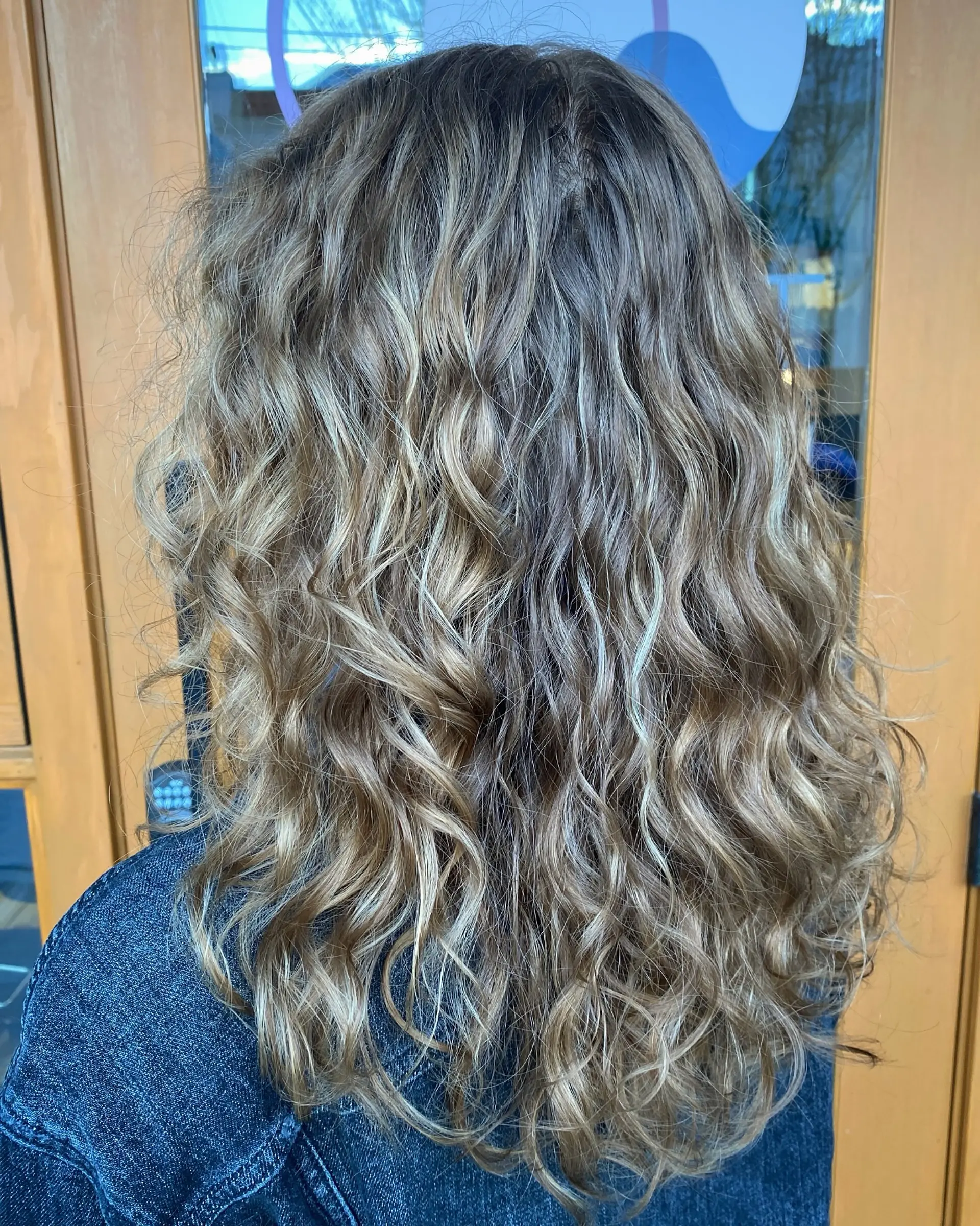 Long wavy hair with subtle blonde highlights and defined natural texture. 1