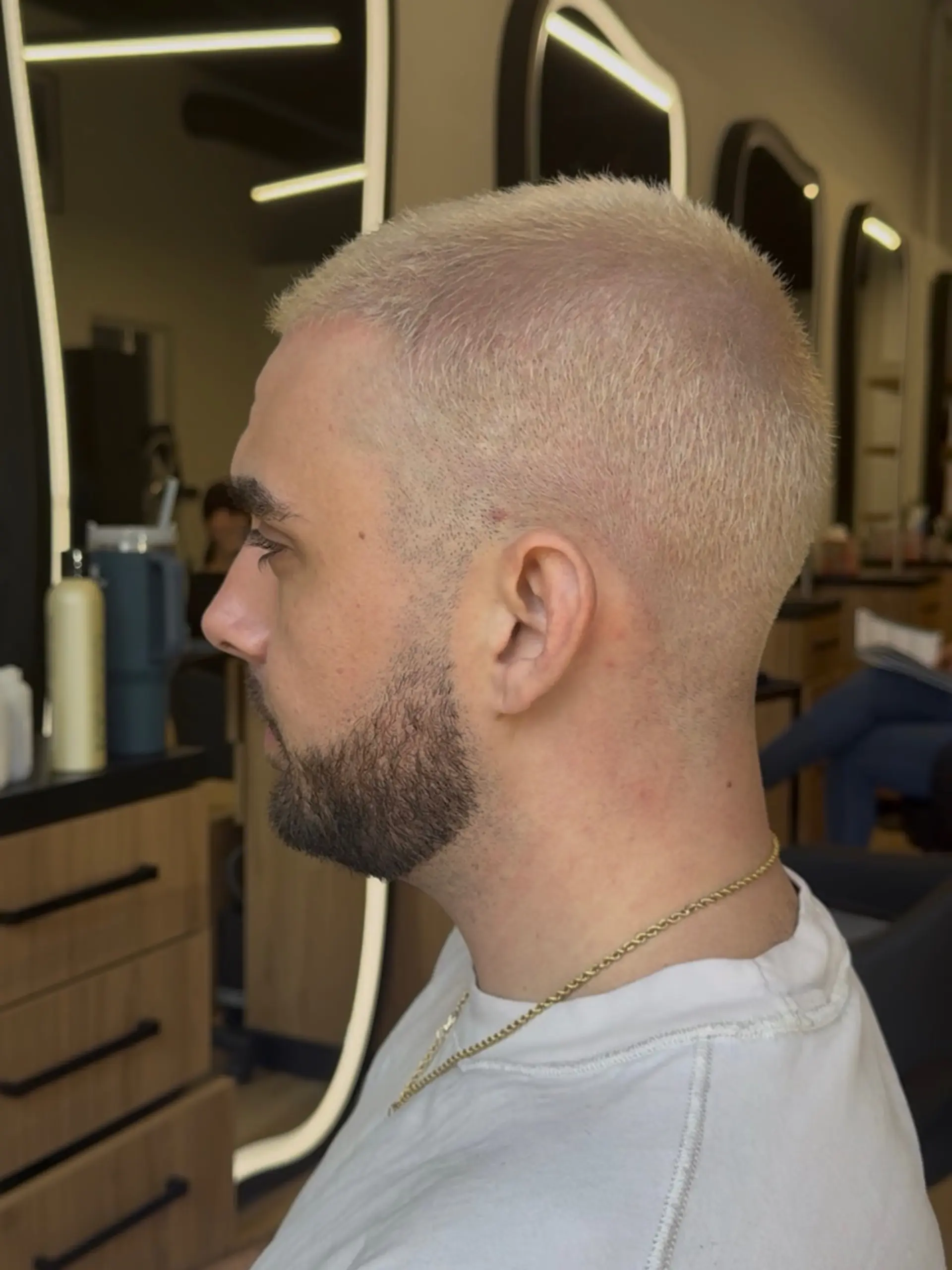 Short platinum blonde buzz cut with neatly trimmed sides. 1