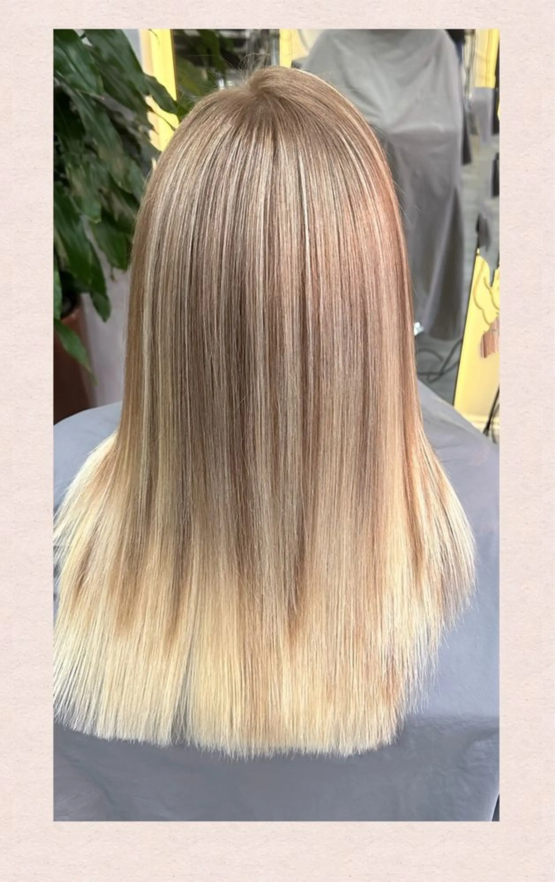 A medium-length, straight hairstyle with a blonde balayage and layered ends. 1