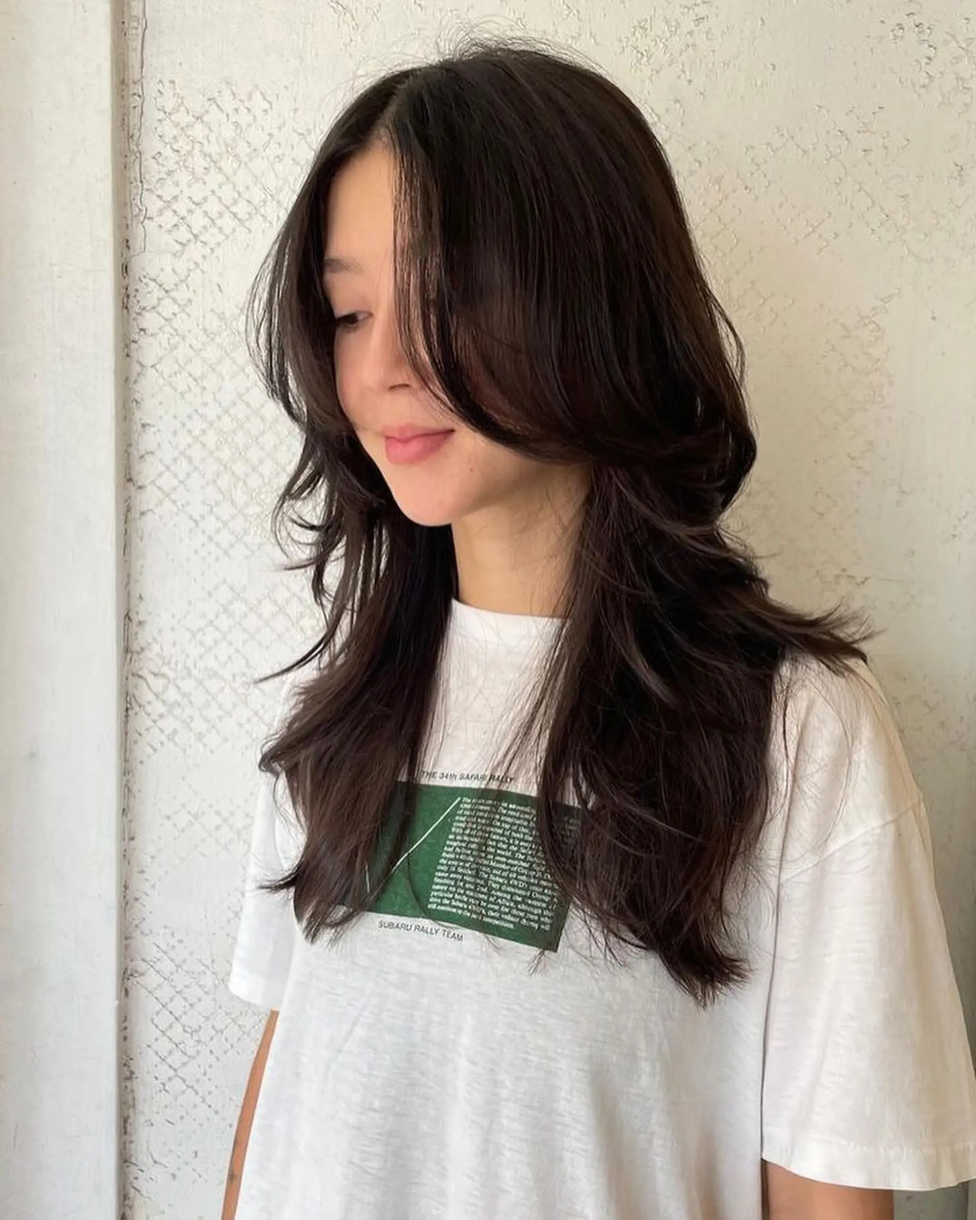 Long wavy dark brown hair with face-framing layers and a side part, creating a full-volume silhouette. 1