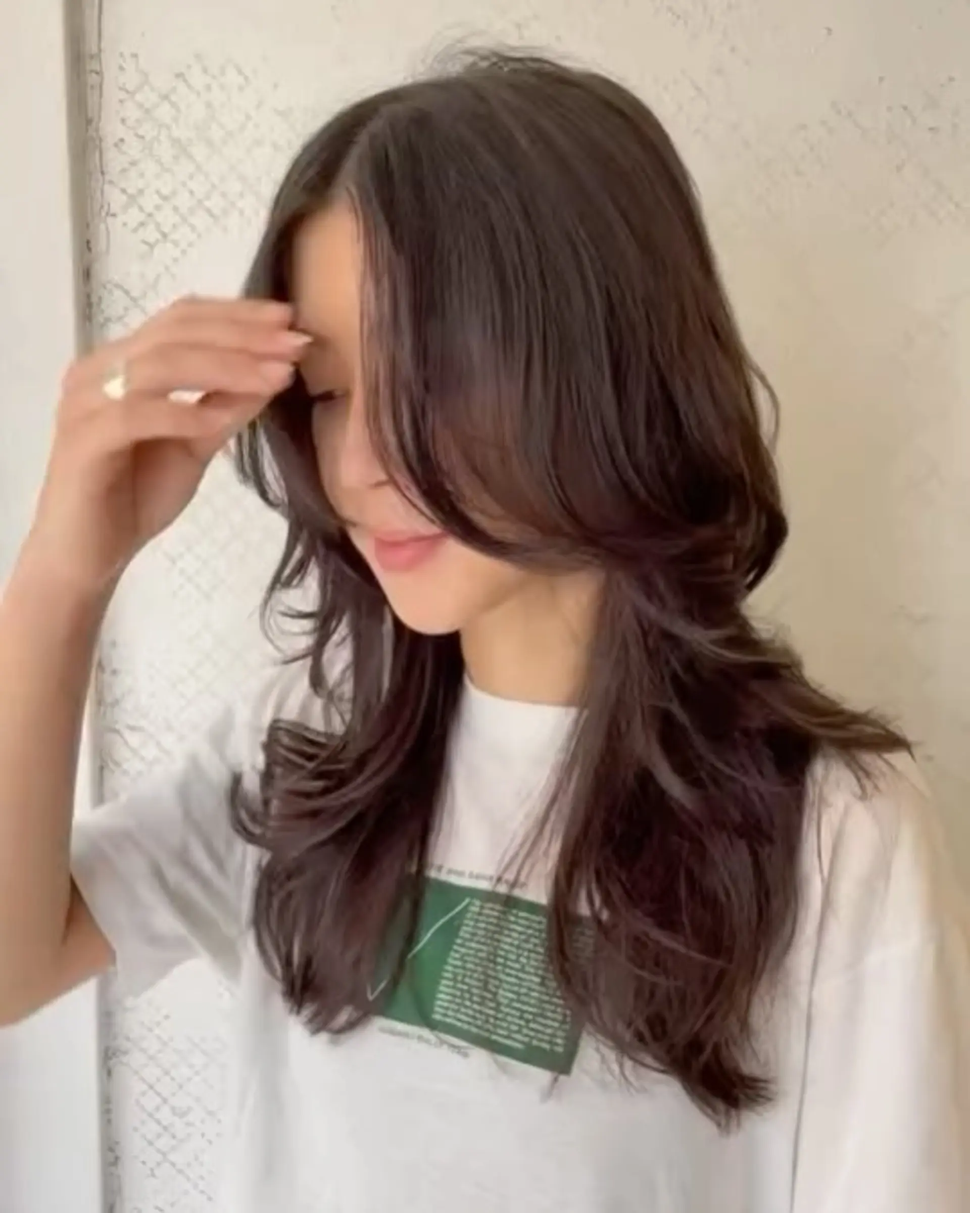 Long wavy dark brown hair with face-framing layers and a side part, creating a full-volume silhouette. 2