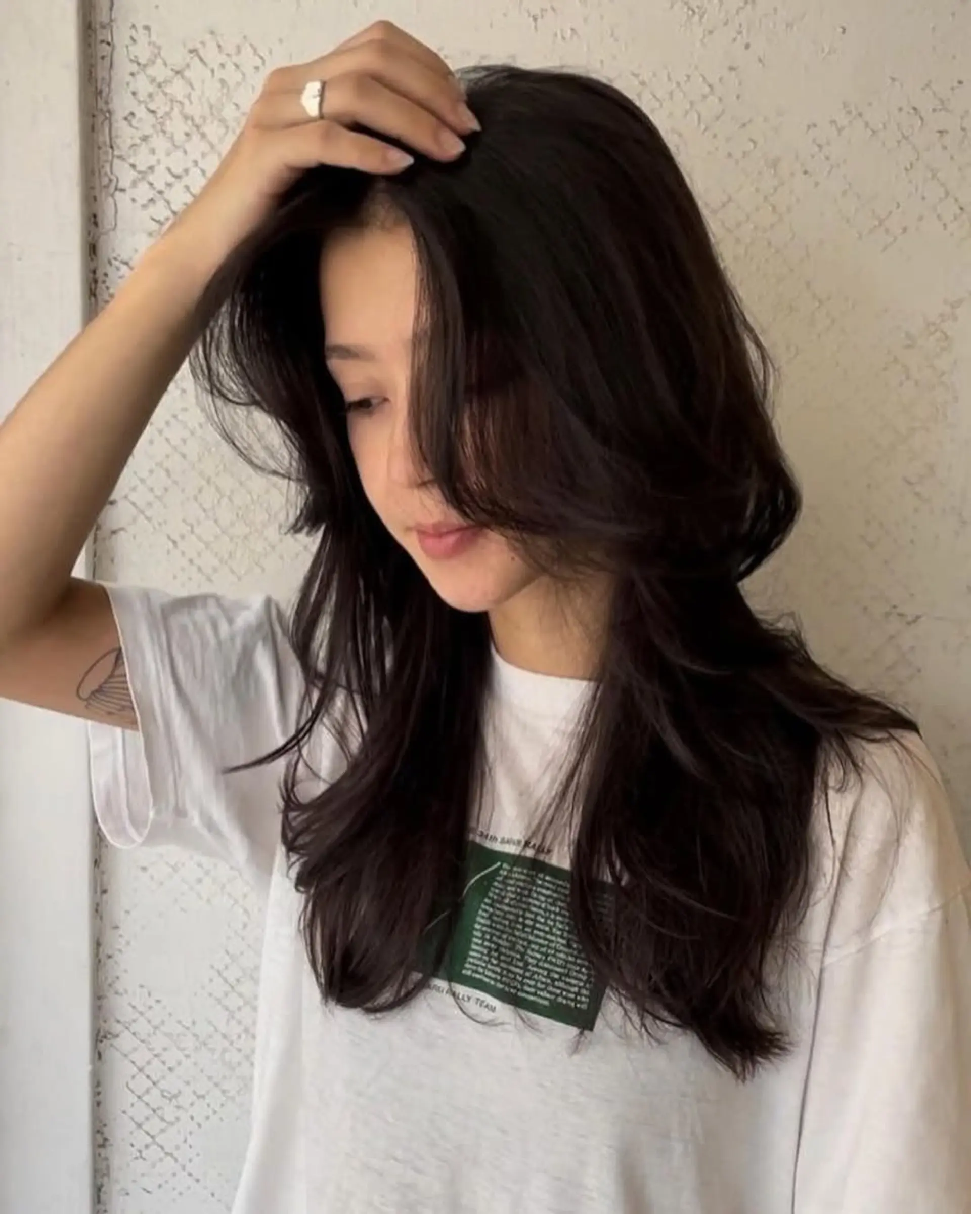 Long wavy dark brown hair with face-framing layers and a side part, creating a full-volume silhouette. 3