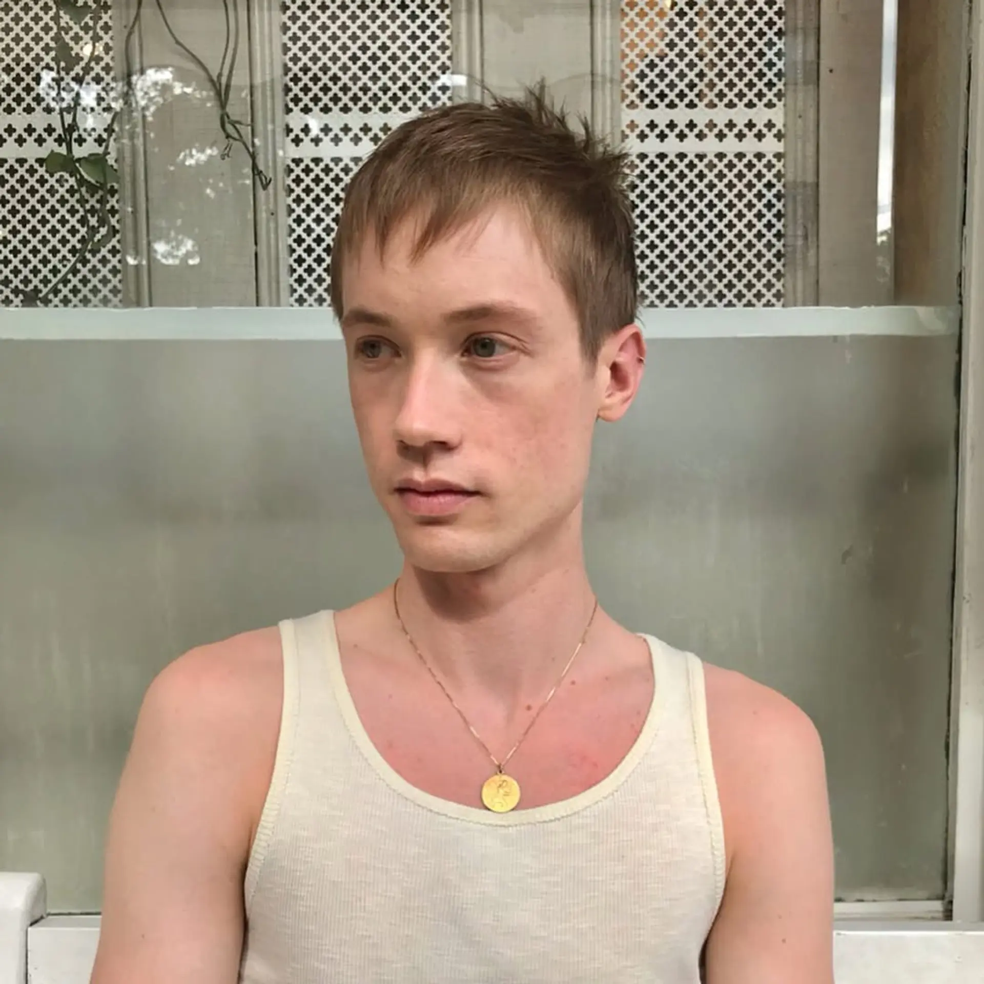 Short, light brown hair styled in a tousled and textured manner with an asymmetric fringe and tapered sides. 1