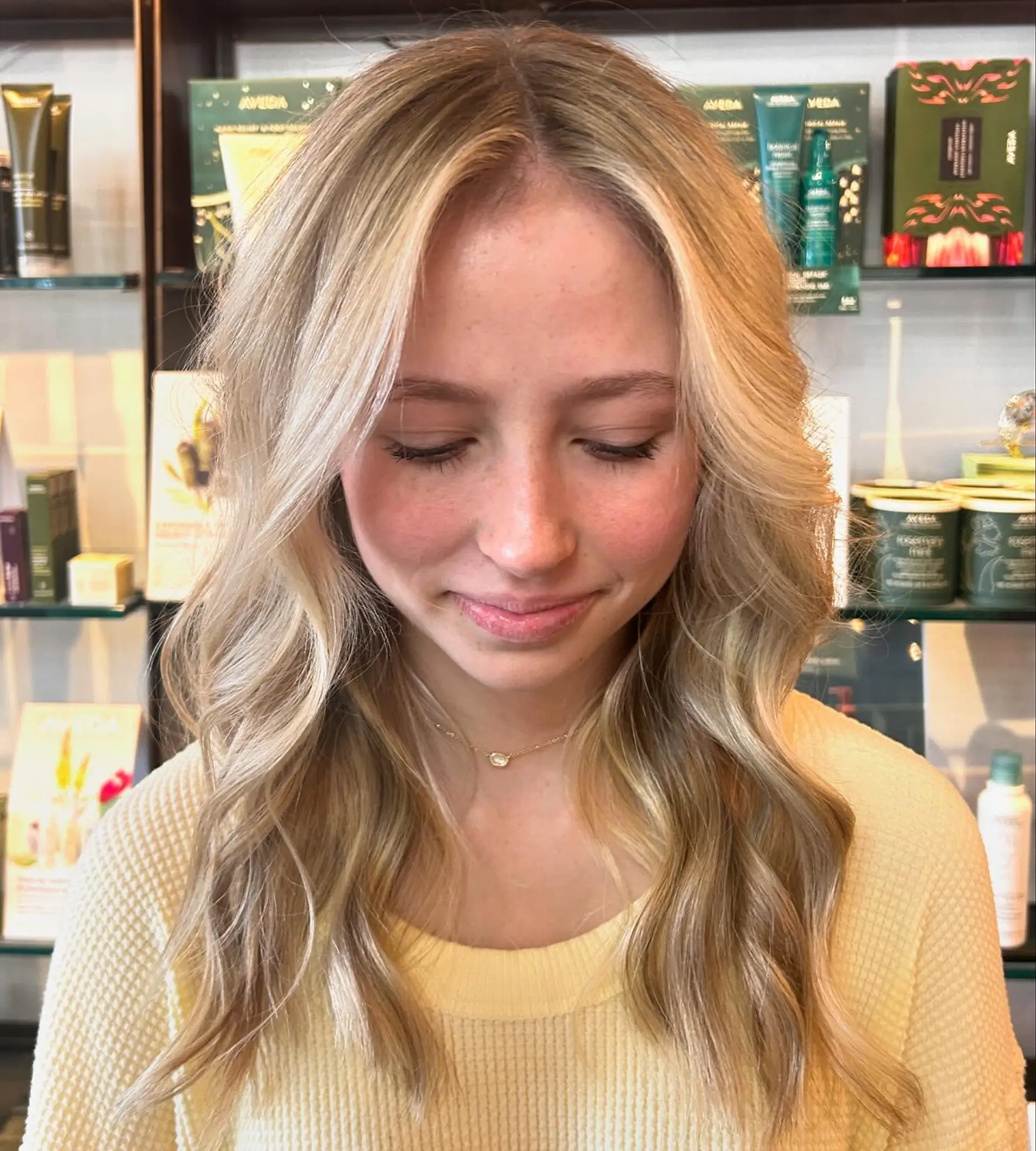 Luminous multi-tonal blonde balayage with a bright face-framing money piece, styled into soft, flowing beach waves. 1