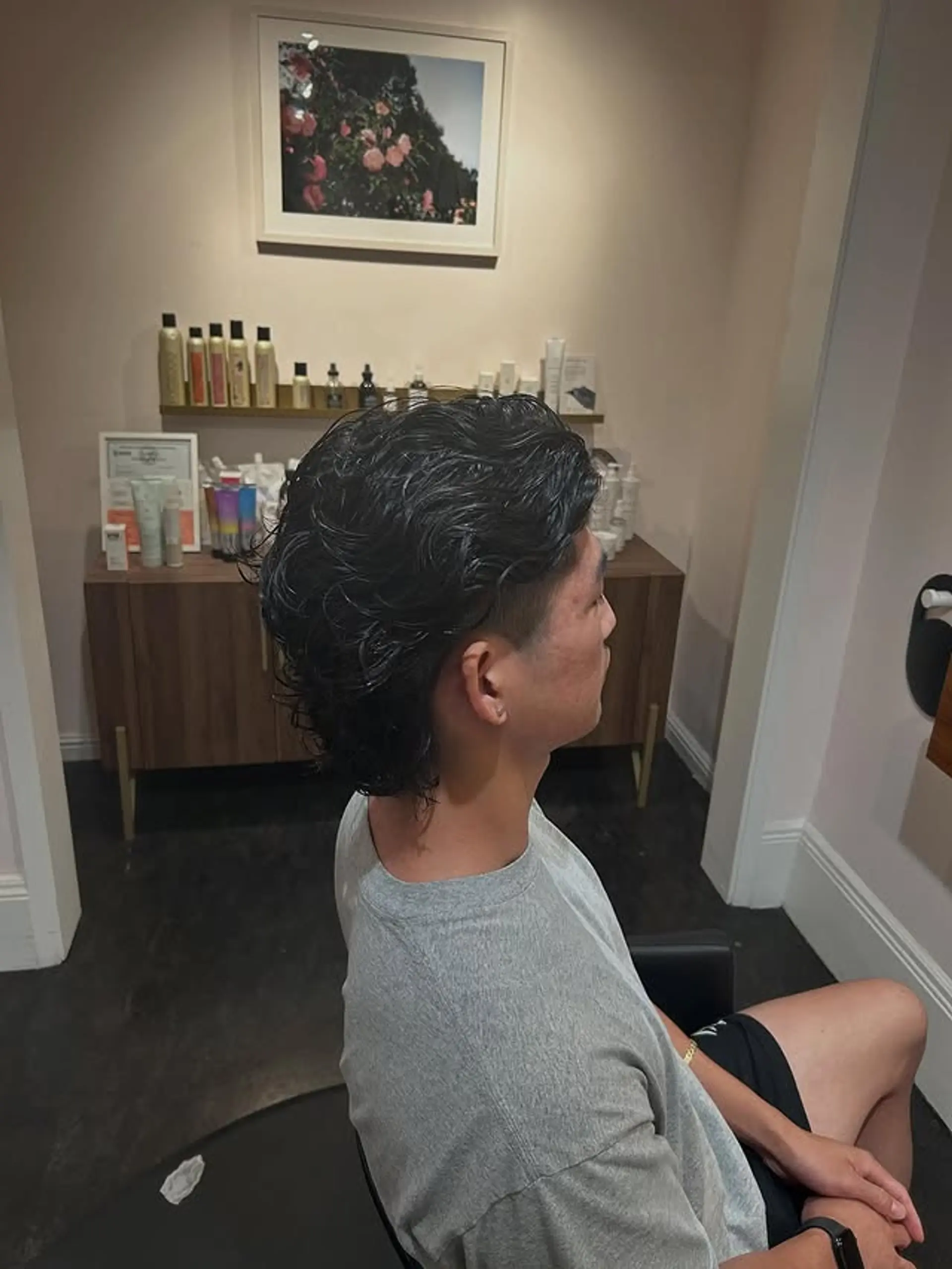 A stylish Wavy Modern Mullet Fade, characterized by its medium-length wavy top and back, combined with sharply faded or undercut sides for a contemporary edge. 1