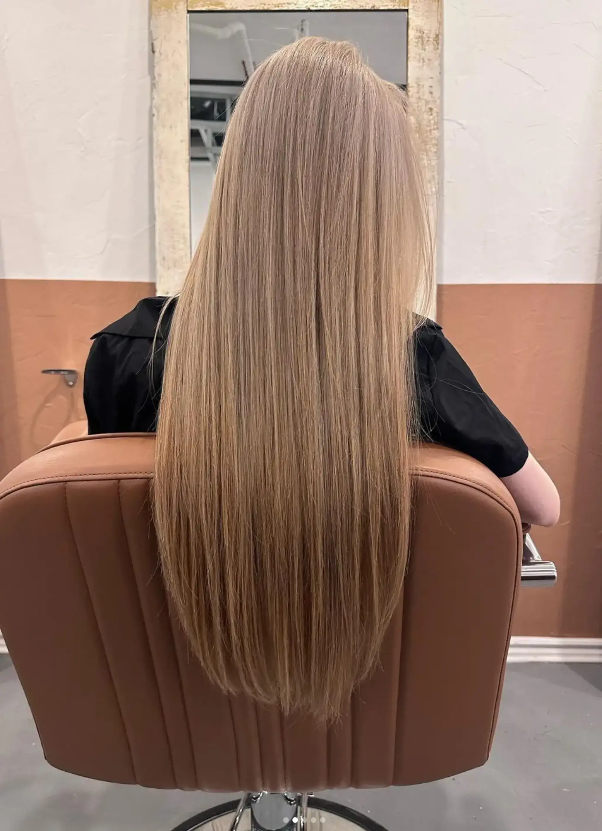 Very long, straight, blonde hair that flows smoothly down the back, with a sleek and shiny finish.