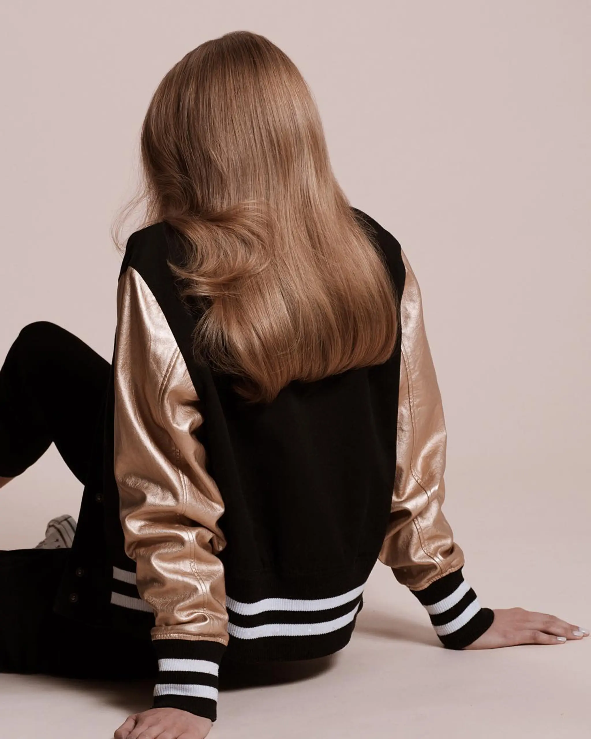 Long, wavy hair with a light brown to golden hue, featuring soft waves and a smooth, natural shine.