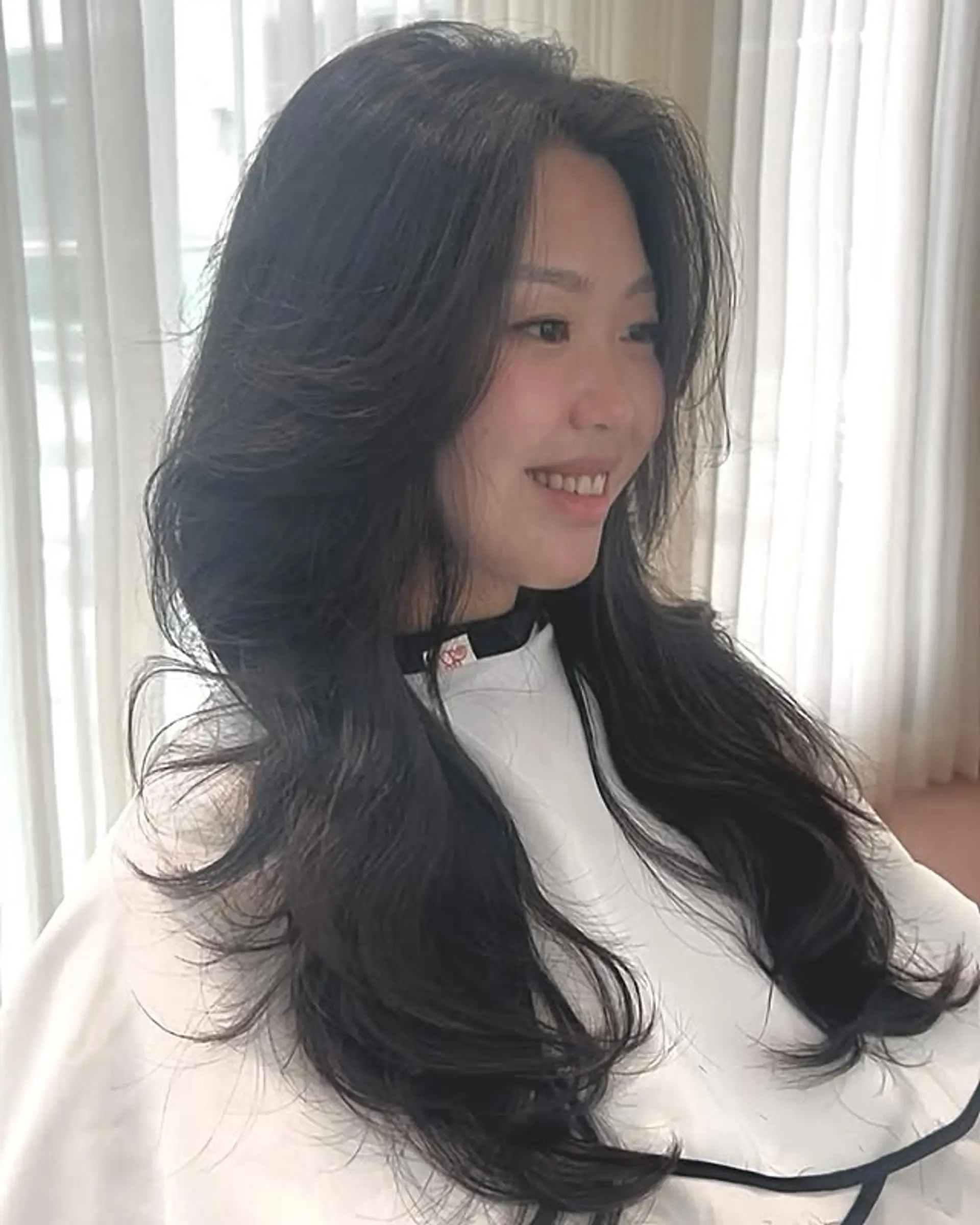 A long, layered haircut with face-framing layers. 1