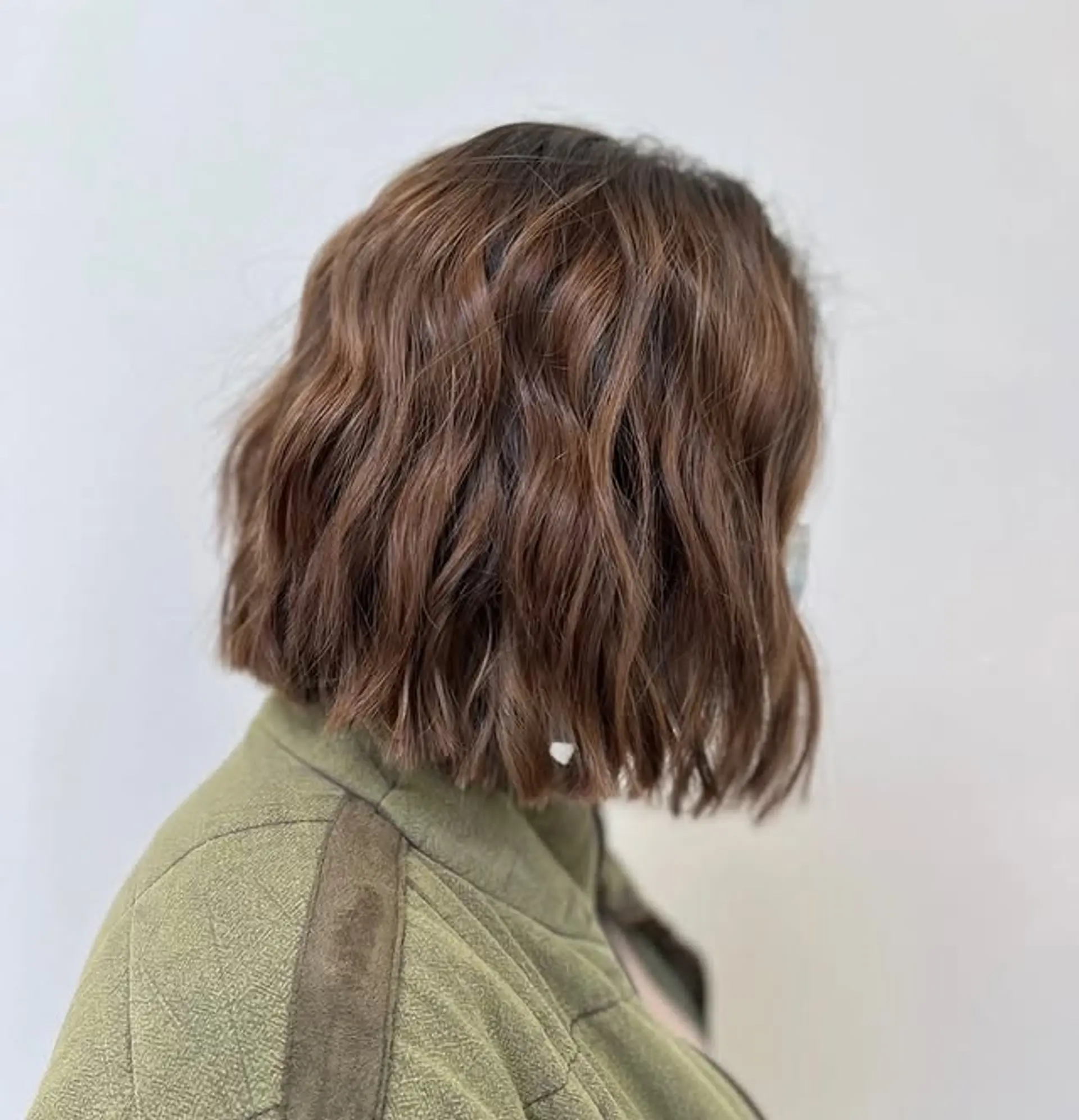 A medium length bob with soft, natural waves and subtle layering for added movement. 1