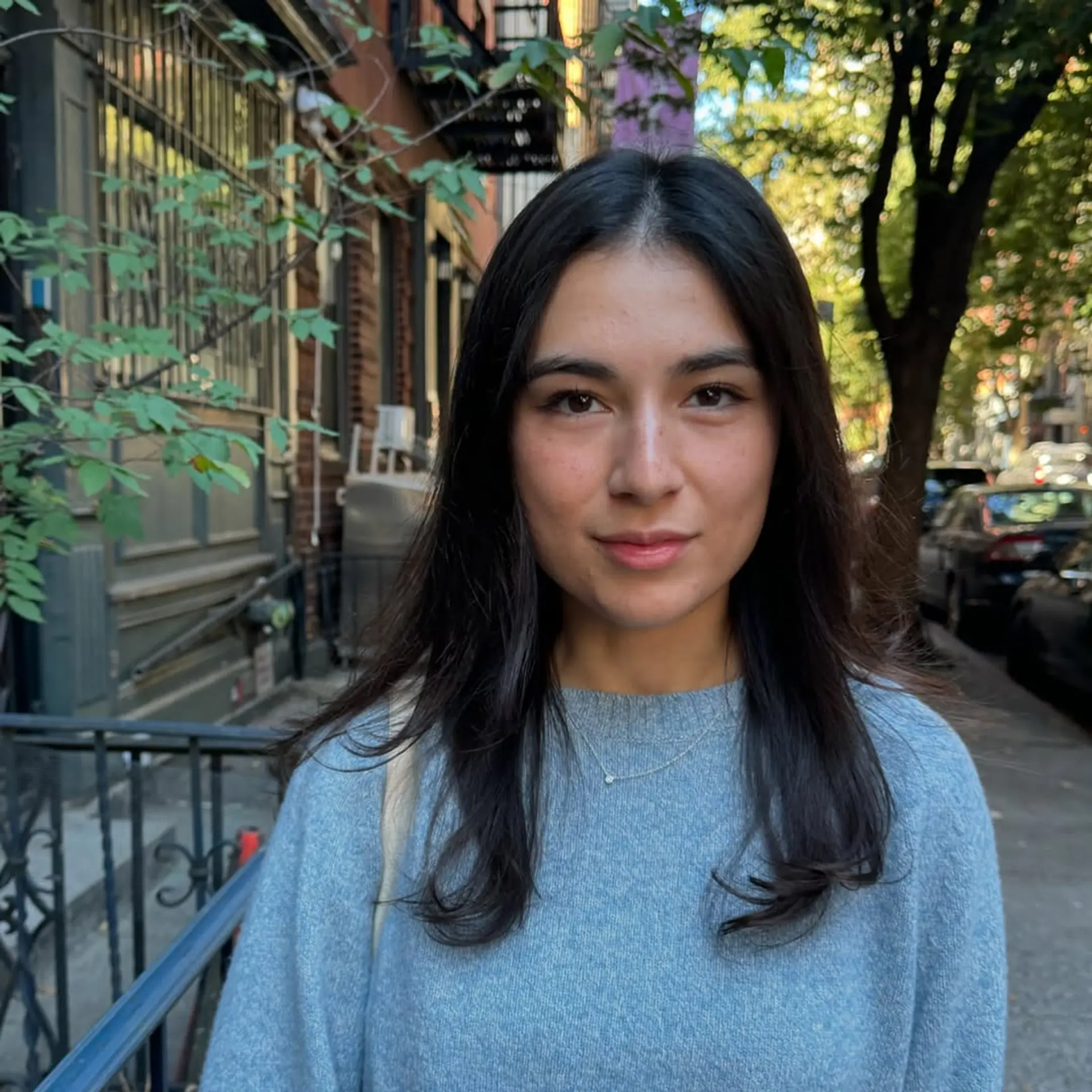 A medium-length cut featuring soft, subtle layers that frame the face and provide natural volume, styled with a simple middle part. 1