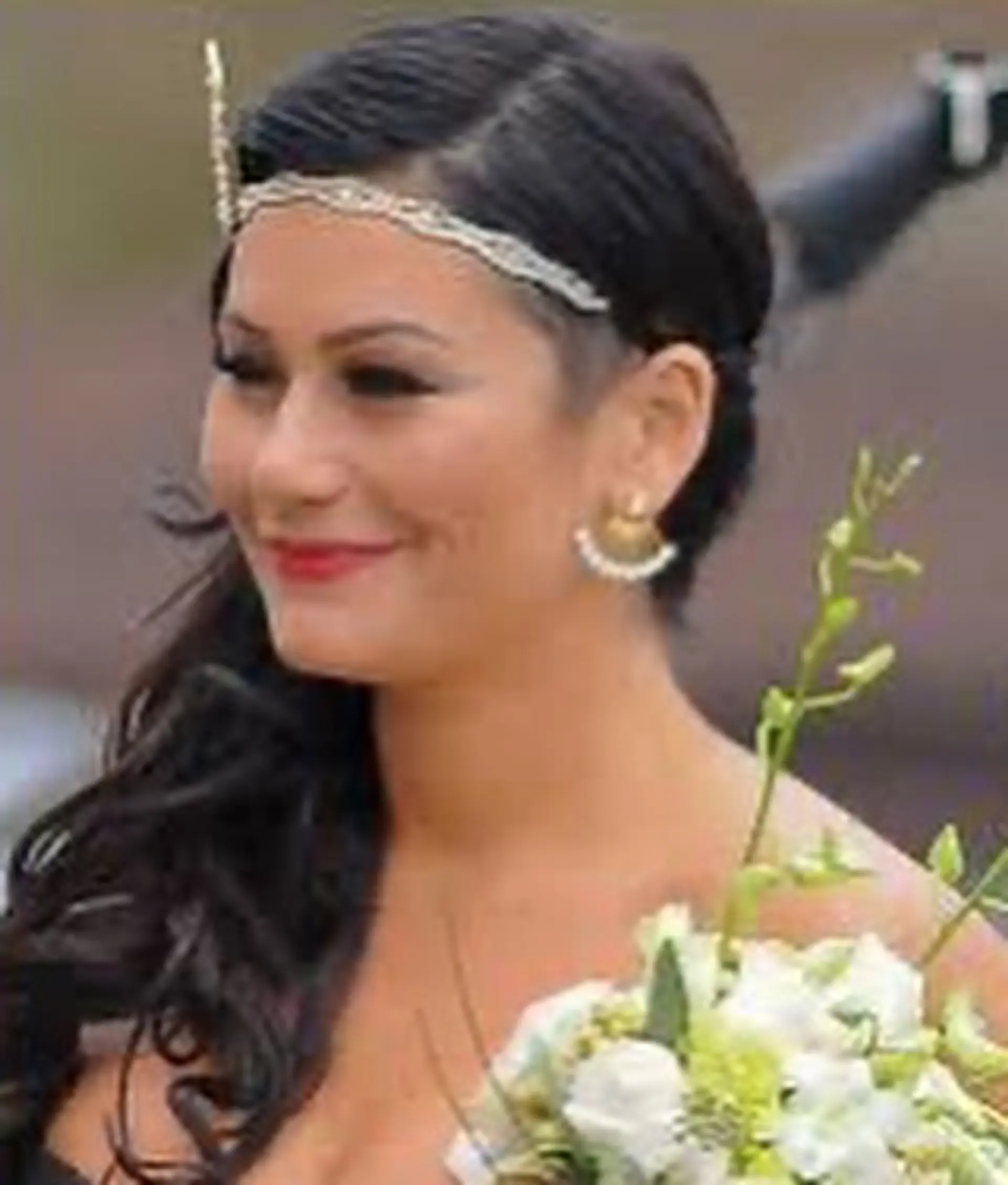 Vintage-inspired side-swept dark curls accented with an ornate beaded headband. 1