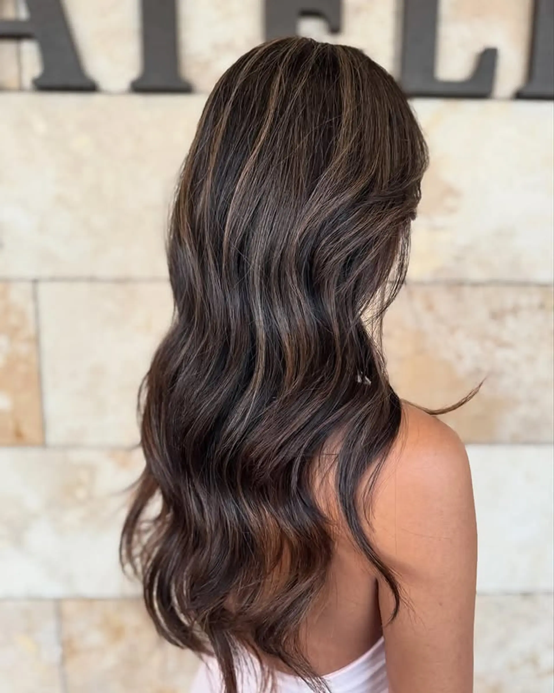 Long, layered waves with balayage highlights. 1