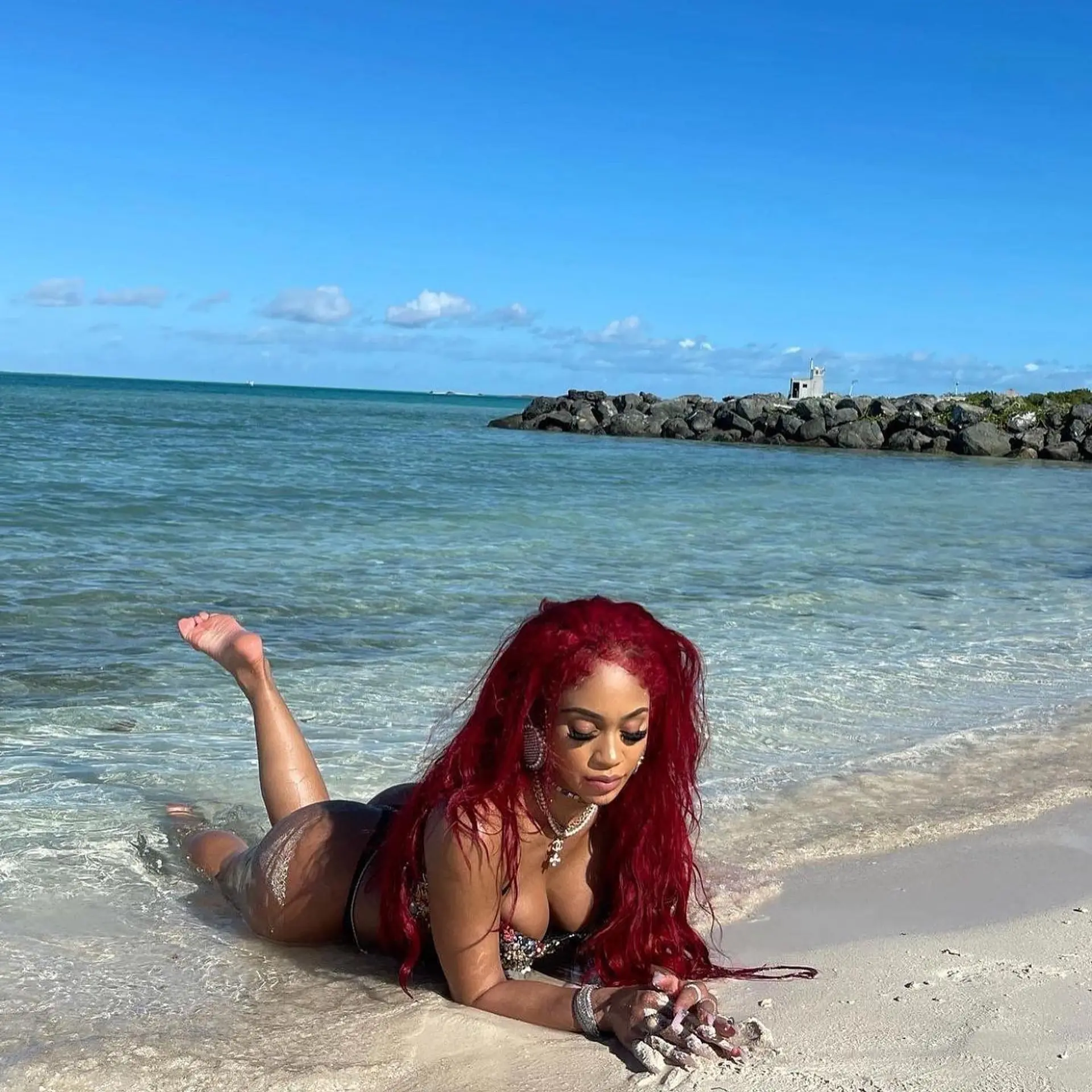 Long, vivid cherry red hair styled in flowing, textured beach waves. 1