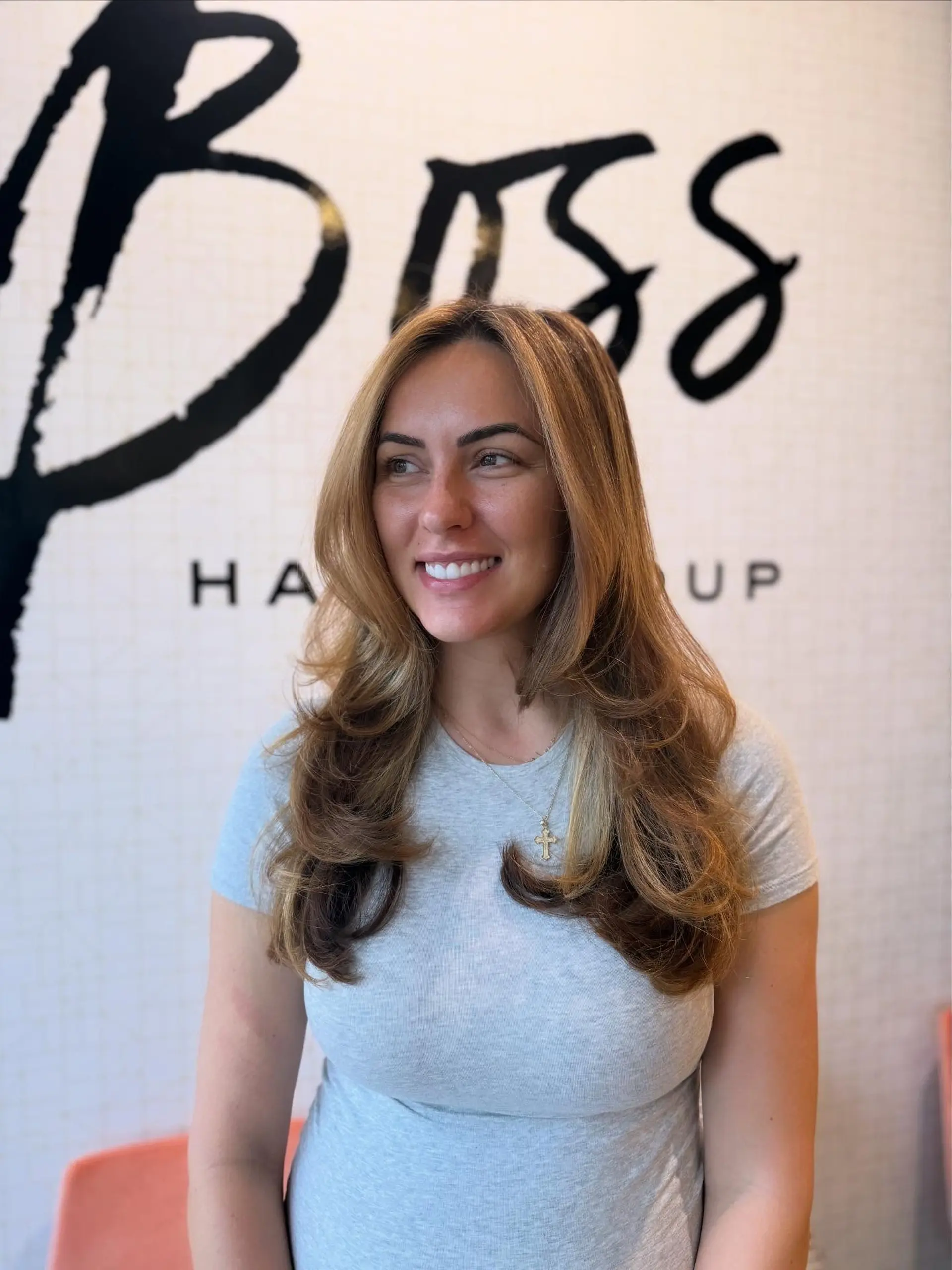A long, layered style finished with a voluminous, bouncy blowout featuring soft flipped ends and face-framing layers. 1
