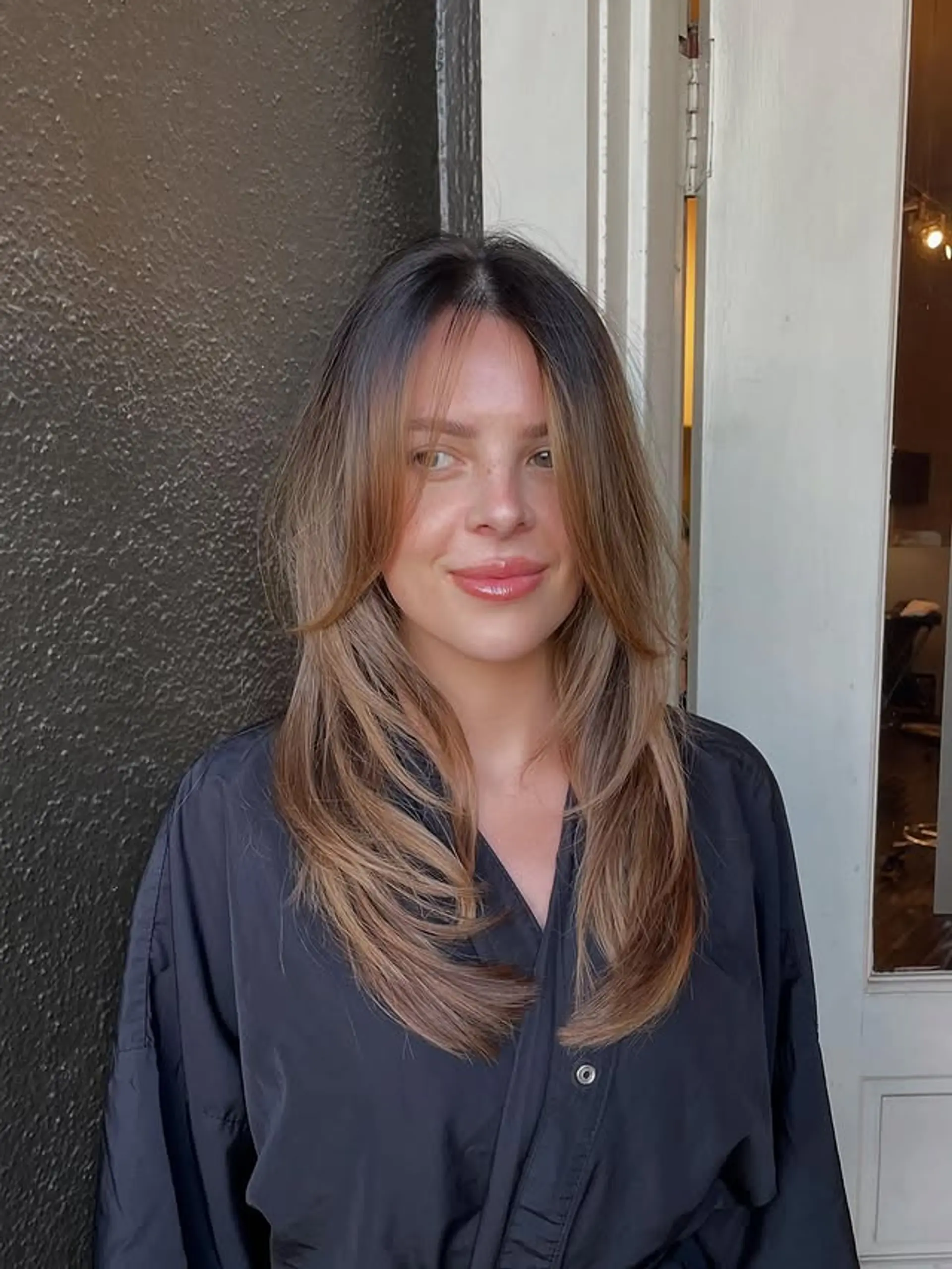 Long layered cut with face-framing and curtain bangs. 1