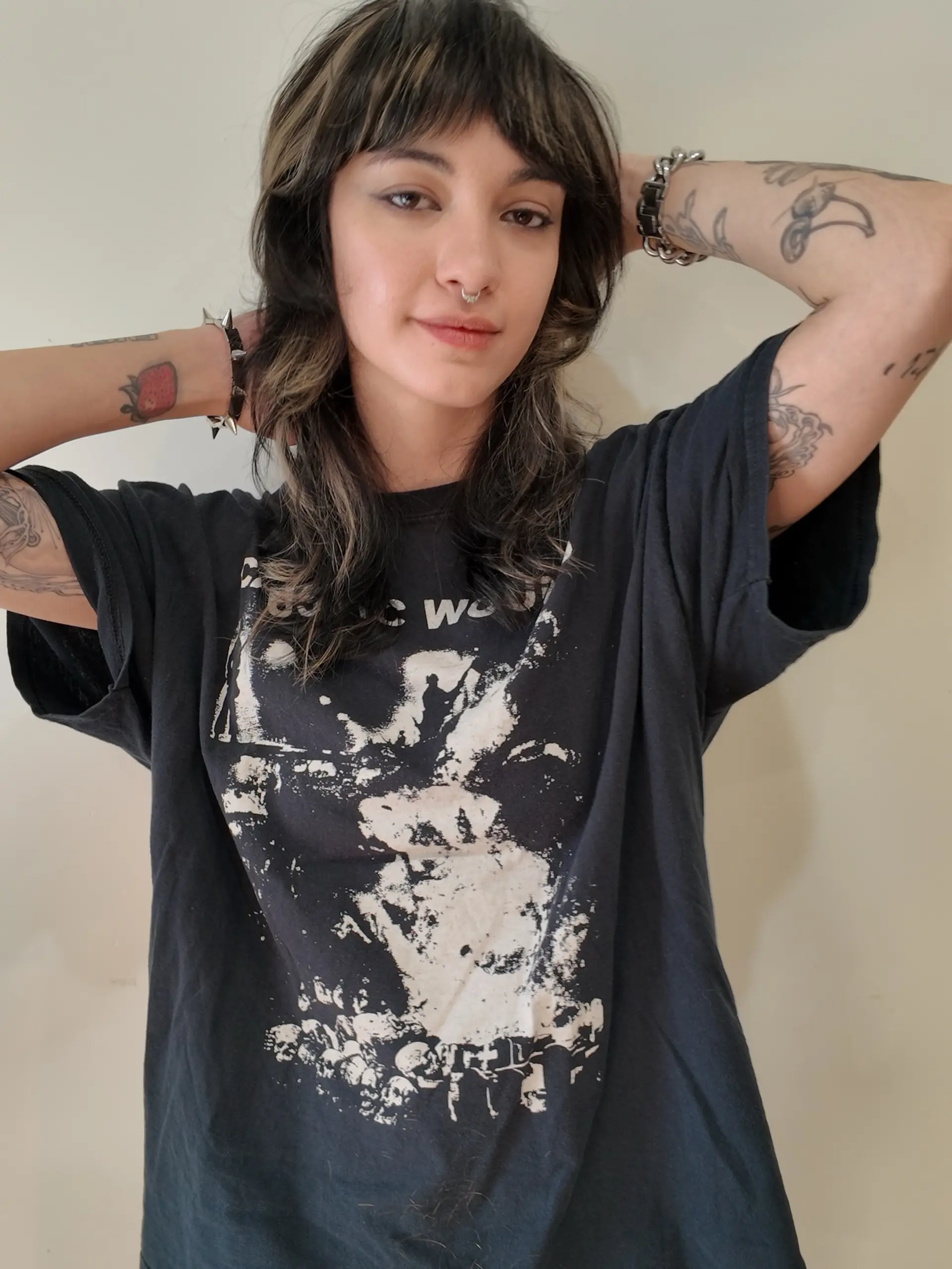 A medium-length textured shag cut with blunt bangs and contrasting chunky ash-blonde highlights over a dark brunette base. 1