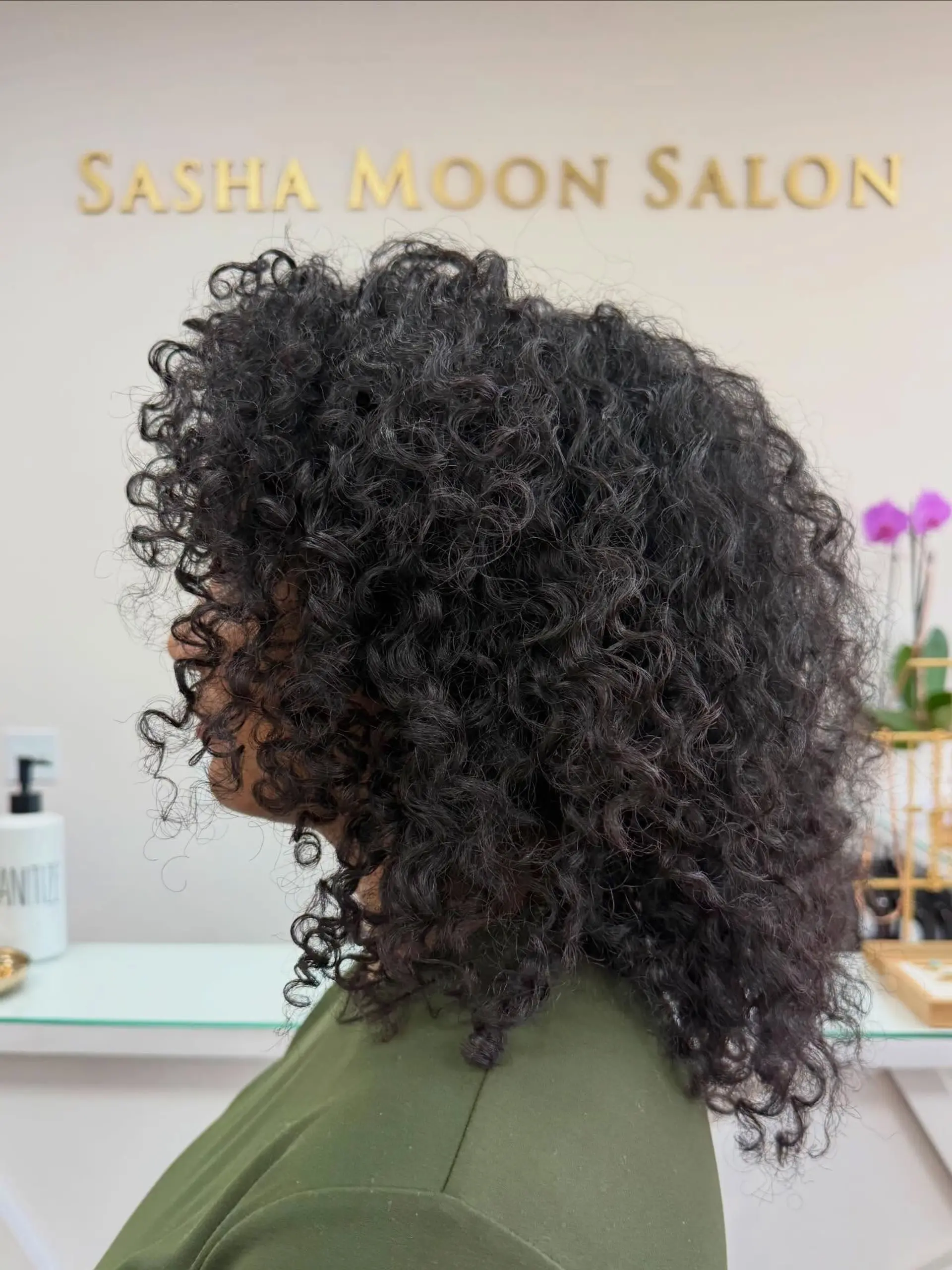 A rounded, shoulder-length dry cut on high-density tight curls, sculpted to enhance natural shape and volume. 1