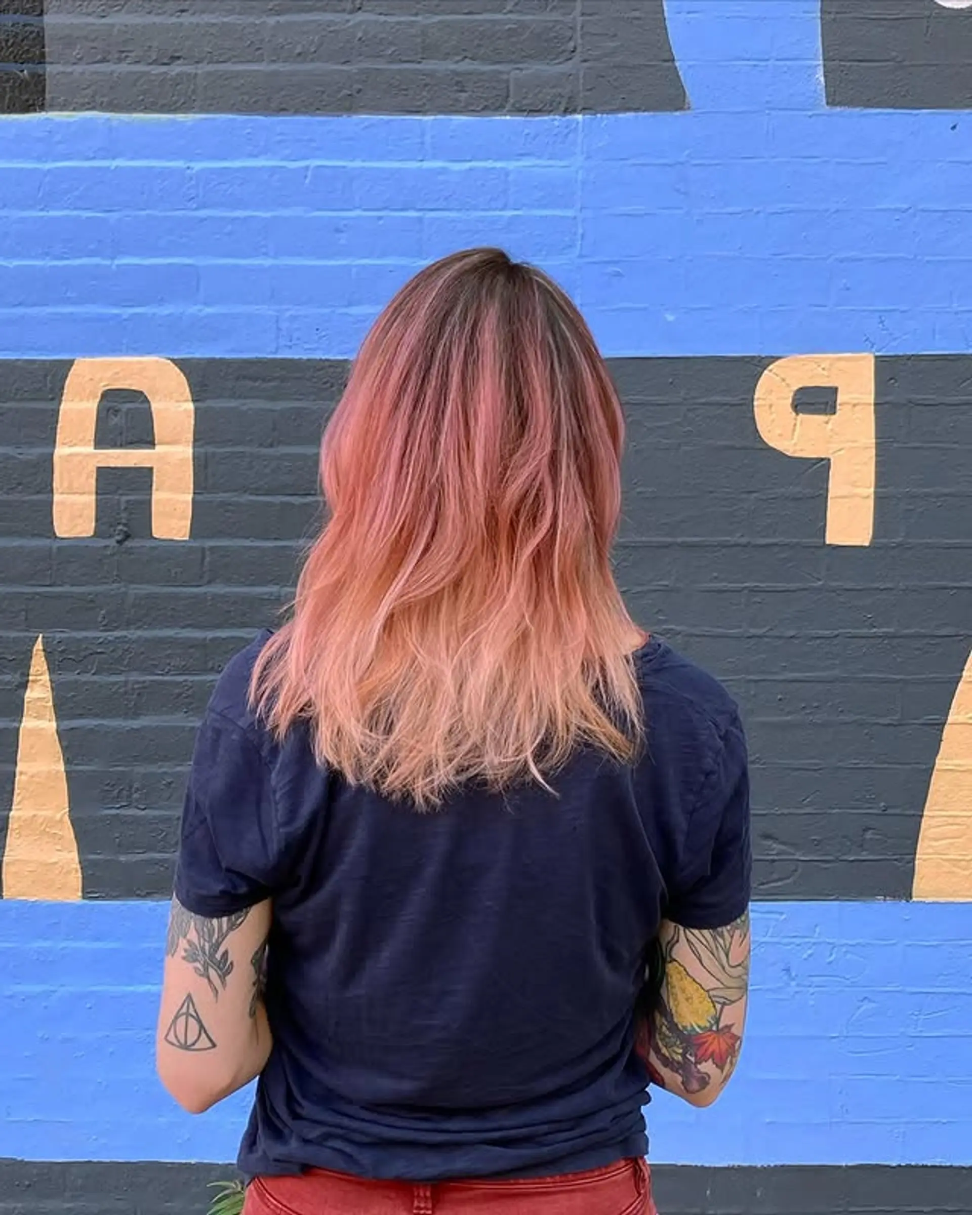 Medium length wavy hair with a rose gold ombre color melt. 1