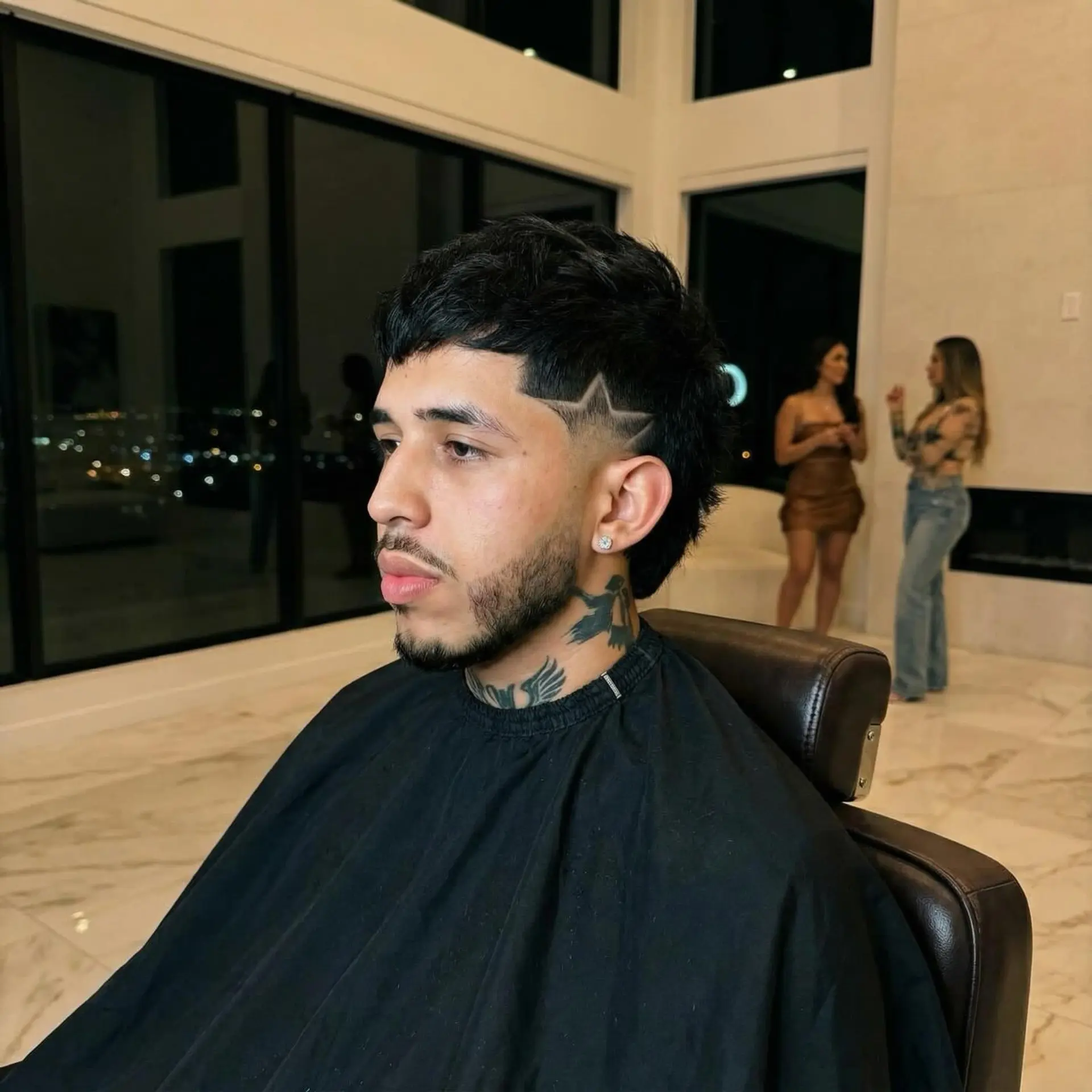 A modern textured mullet featuring a temple fade with a sharp shaved star design and a clean beard line-up. 1