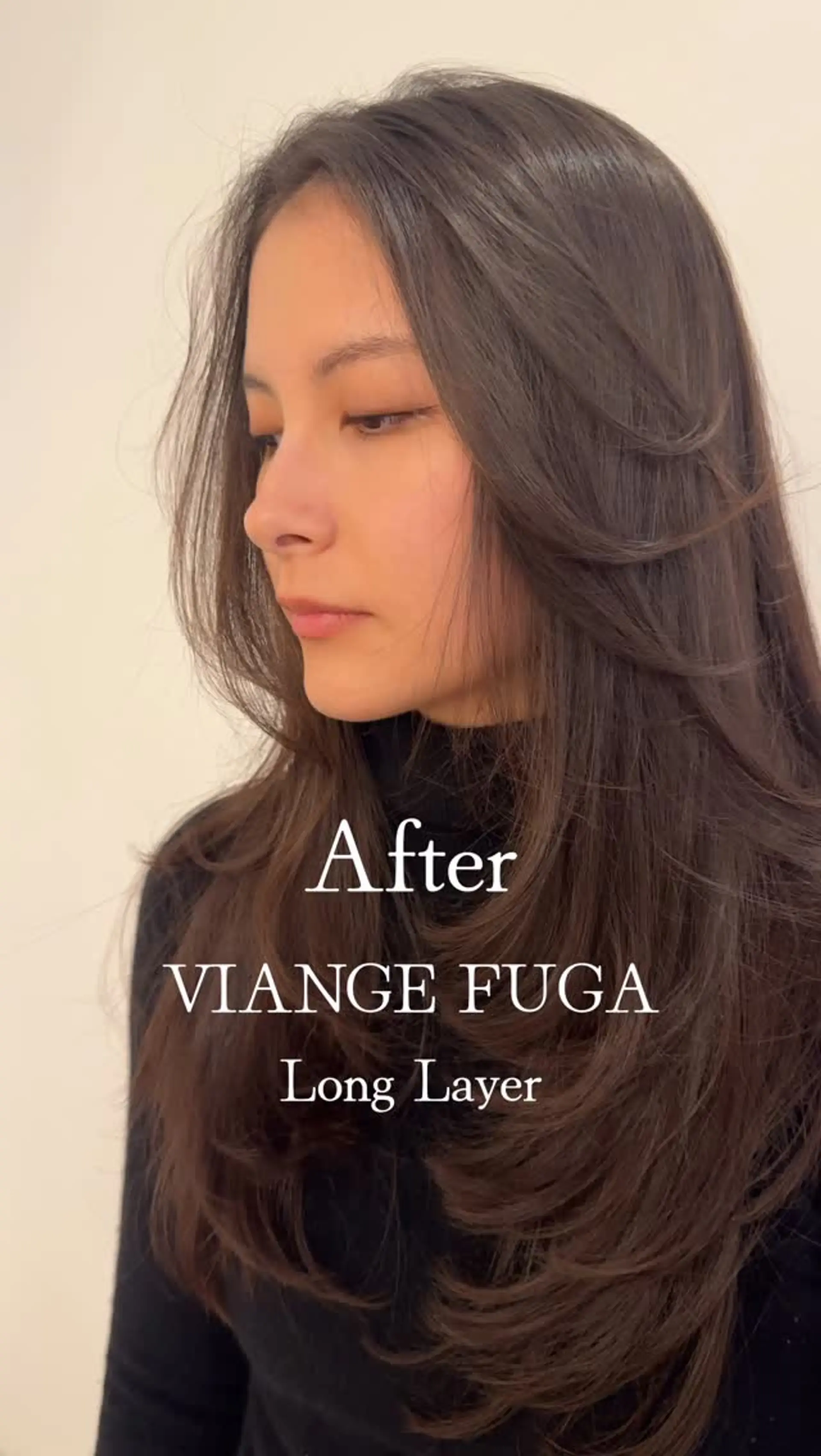 Long dark brown haircut styled with soft, cascading layers and feathered face-framing pieces curved inward at the ends. 1