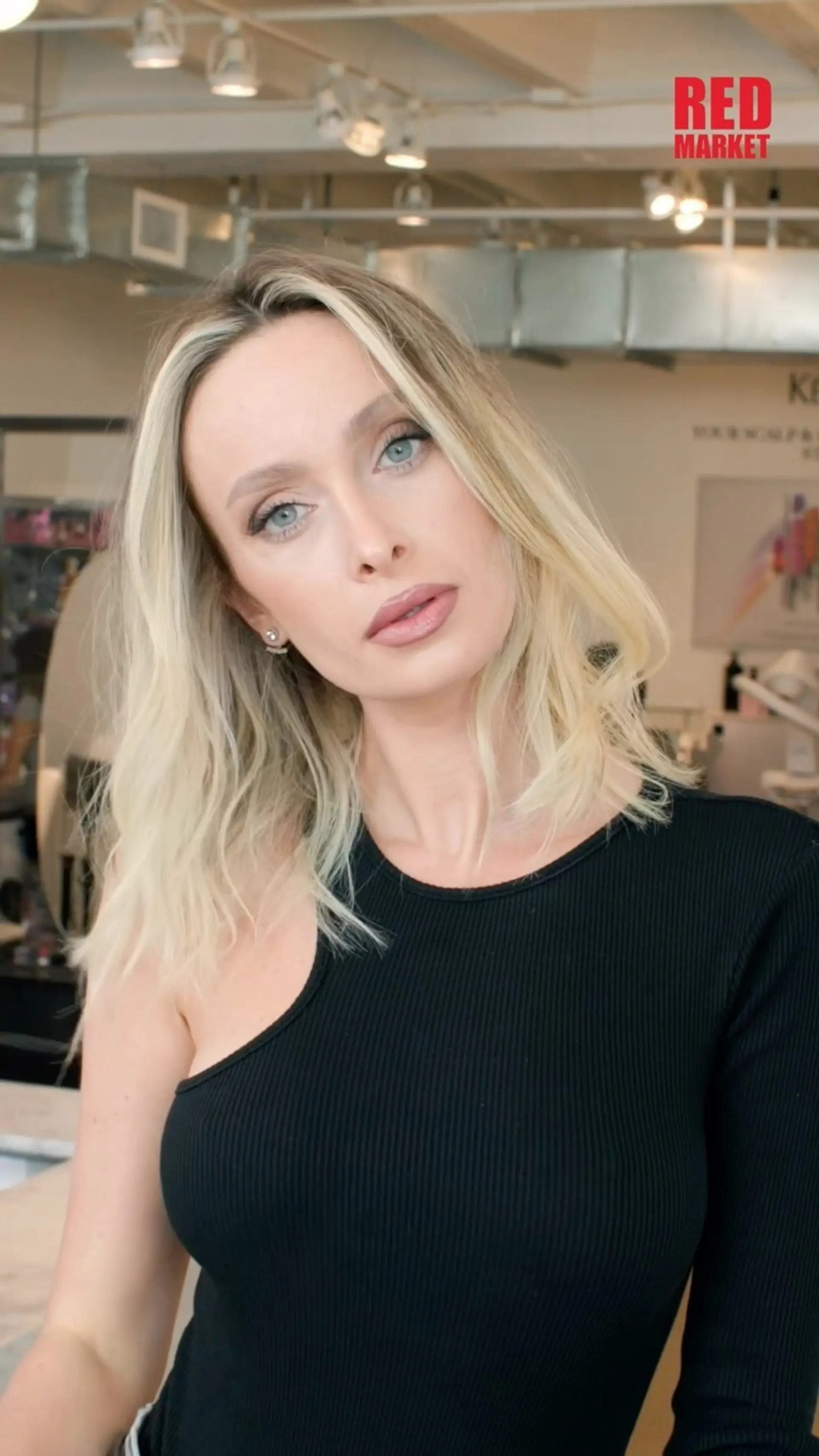 A collarbone-length blonde lob cut with textured, soft beach waves and a deep side part. 1