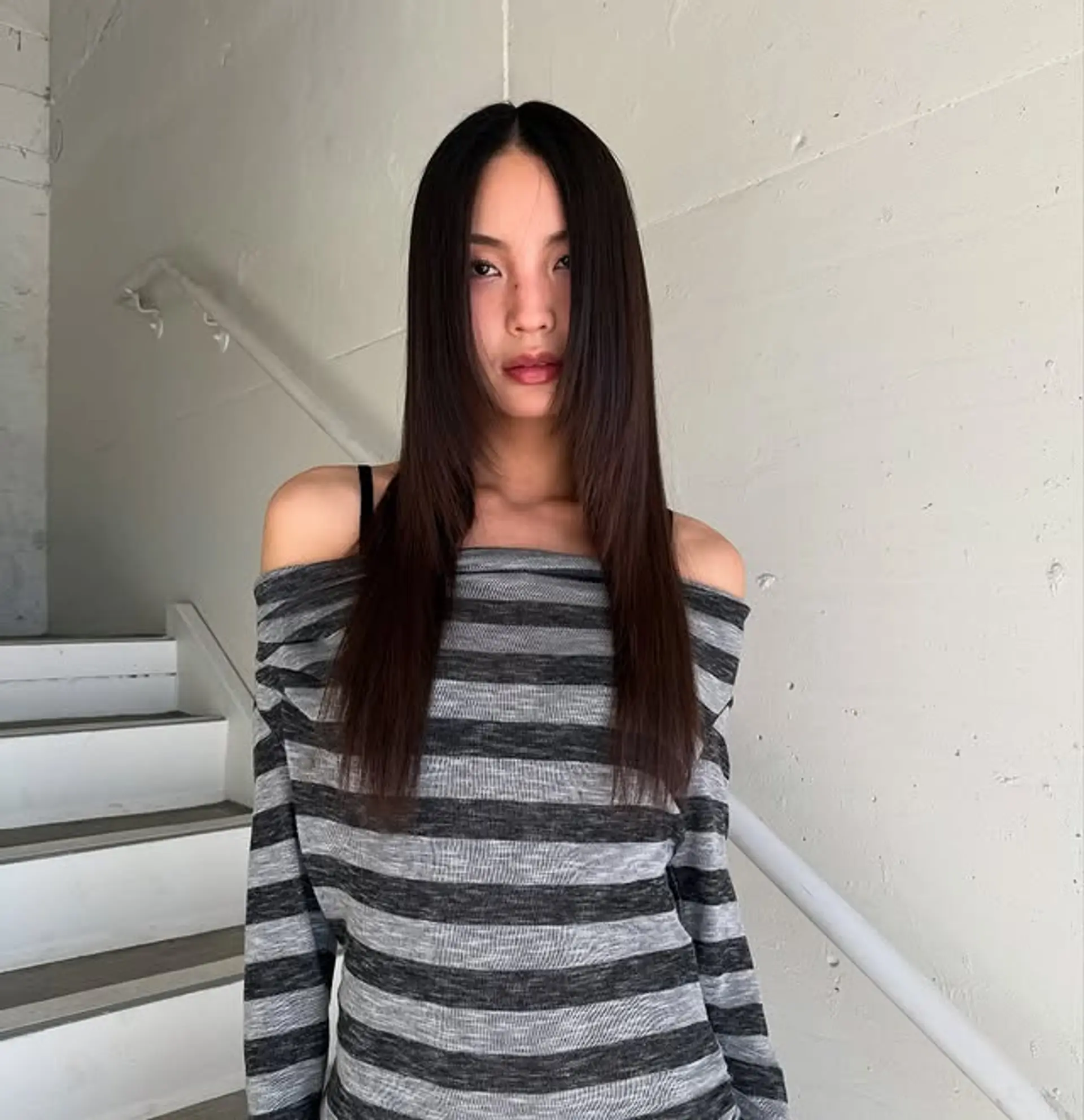 A long layered haircut with curtain bangs and face-framing layers. 1