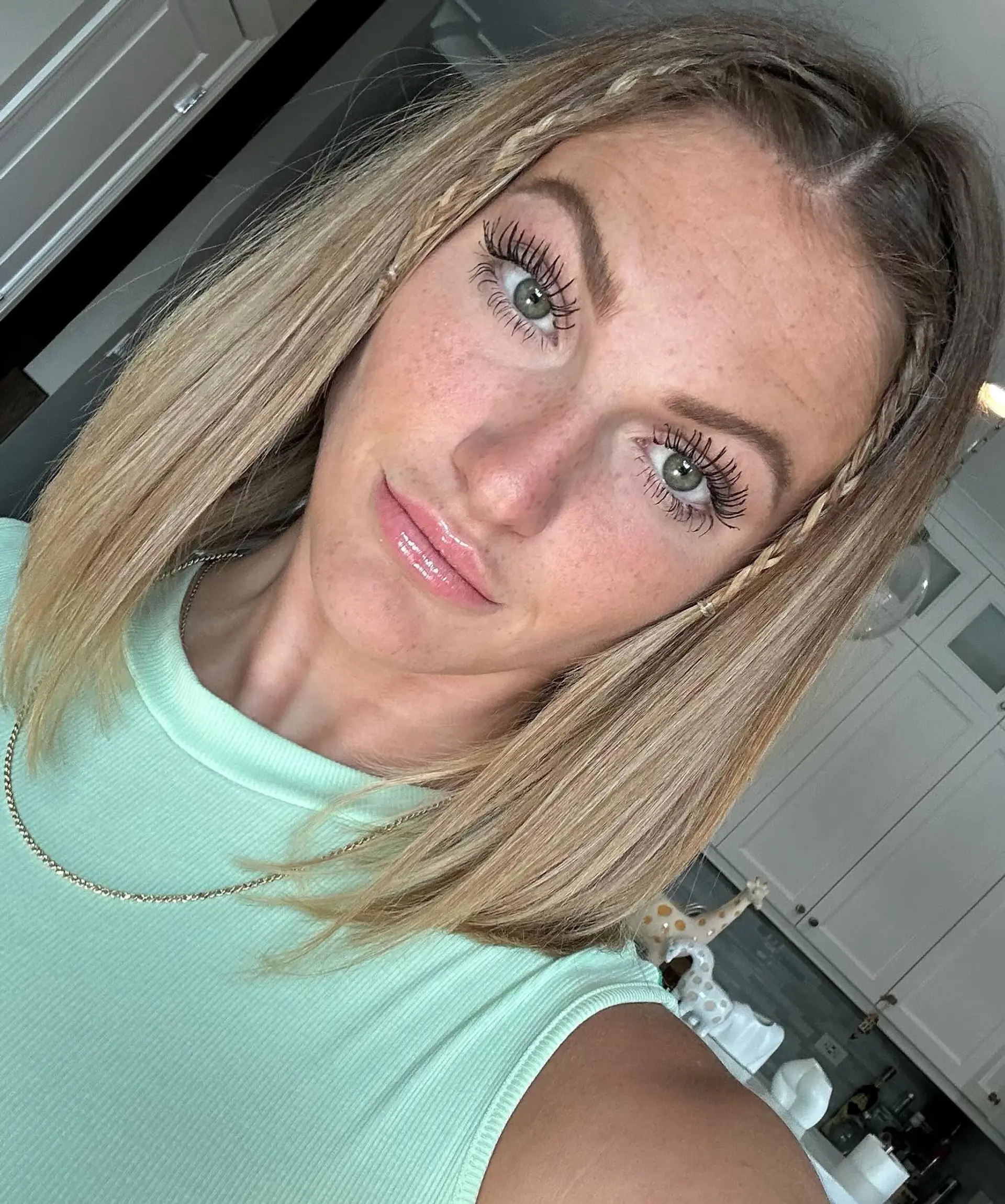 A medium-length blonde bob with delicate side braids, perfect for a boho-chic look. 1