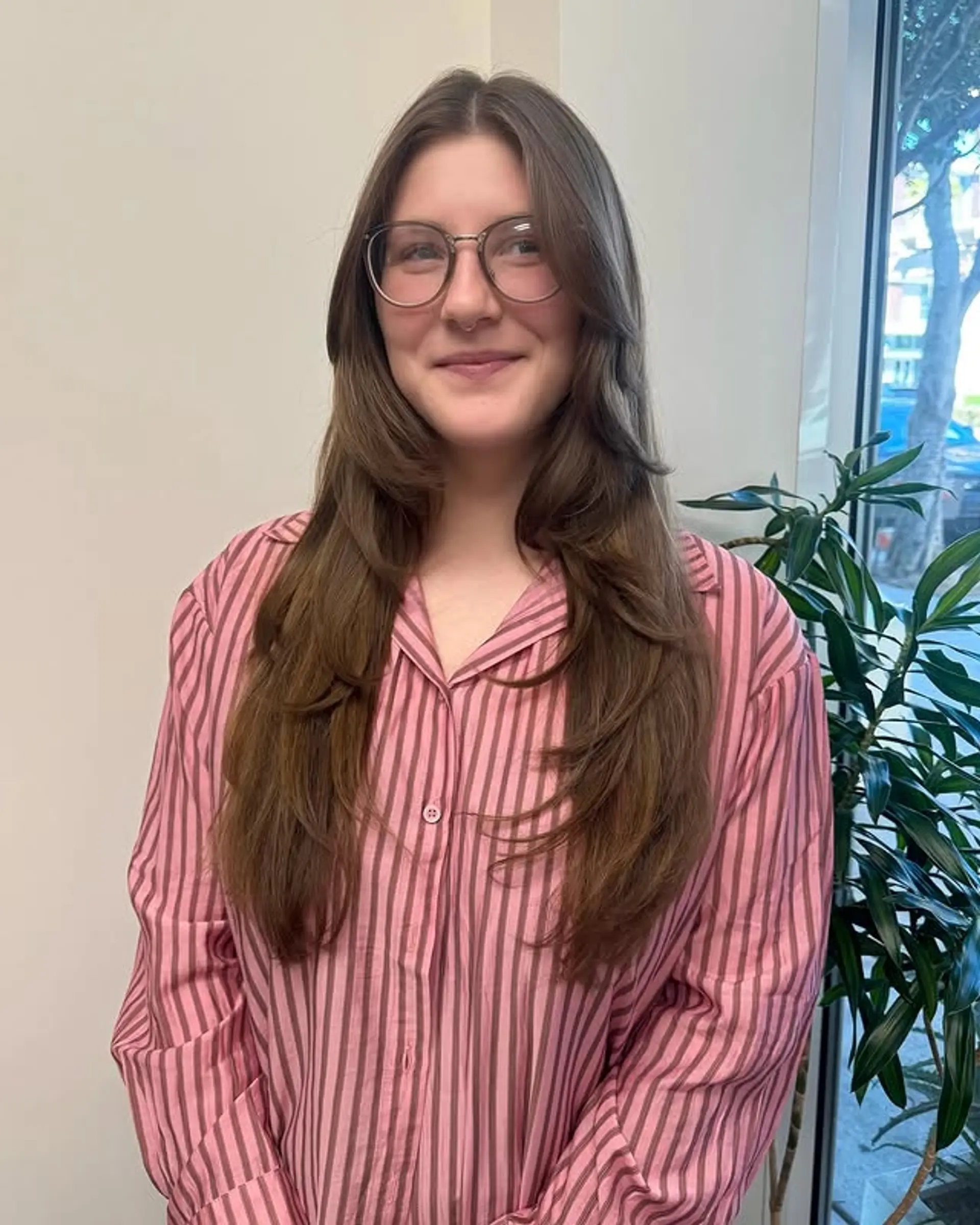 A long layered shag with face-framing layers and a center part. 1